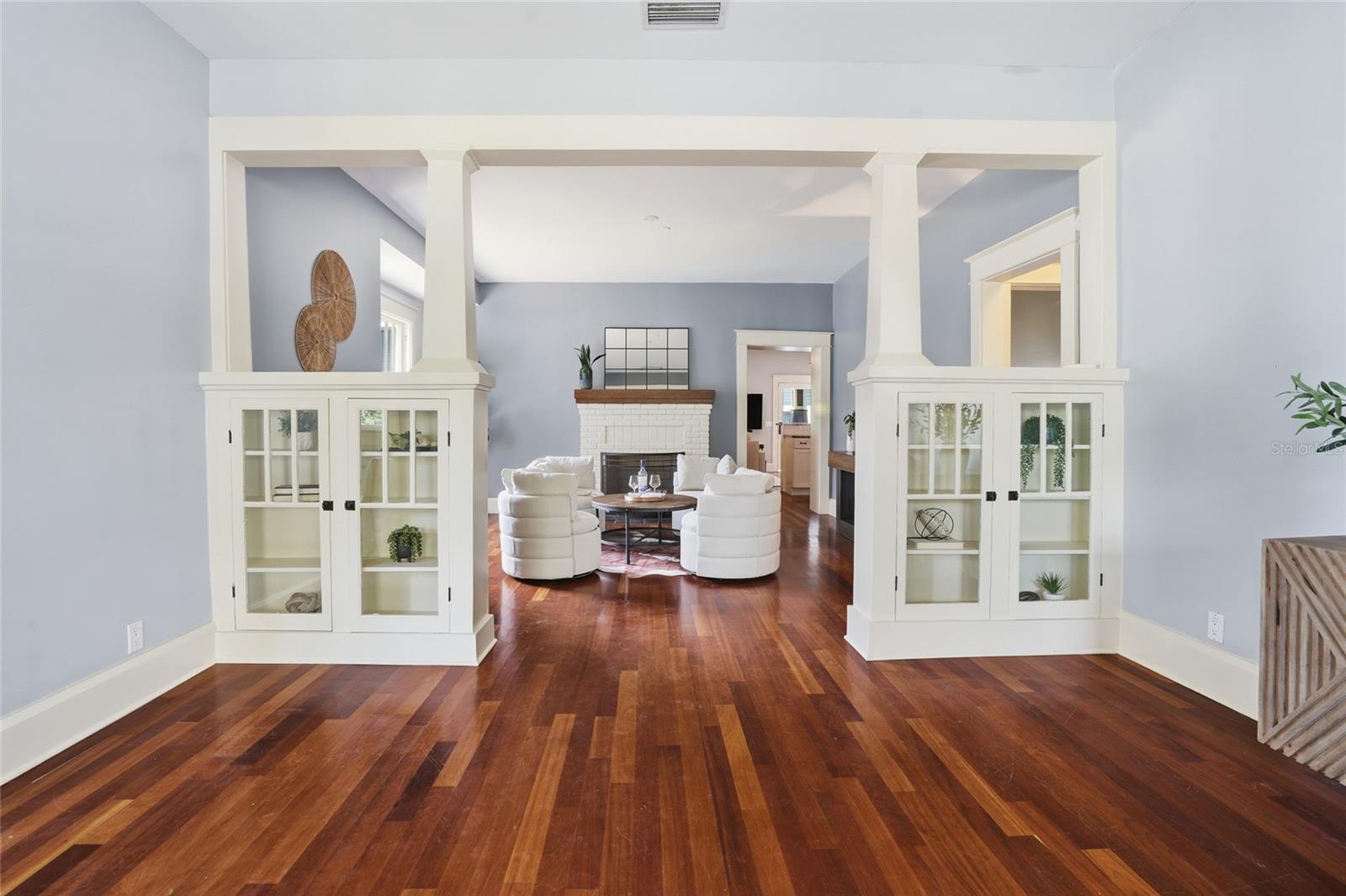 Original built-ins lead you to the formal sitting room with fireplace