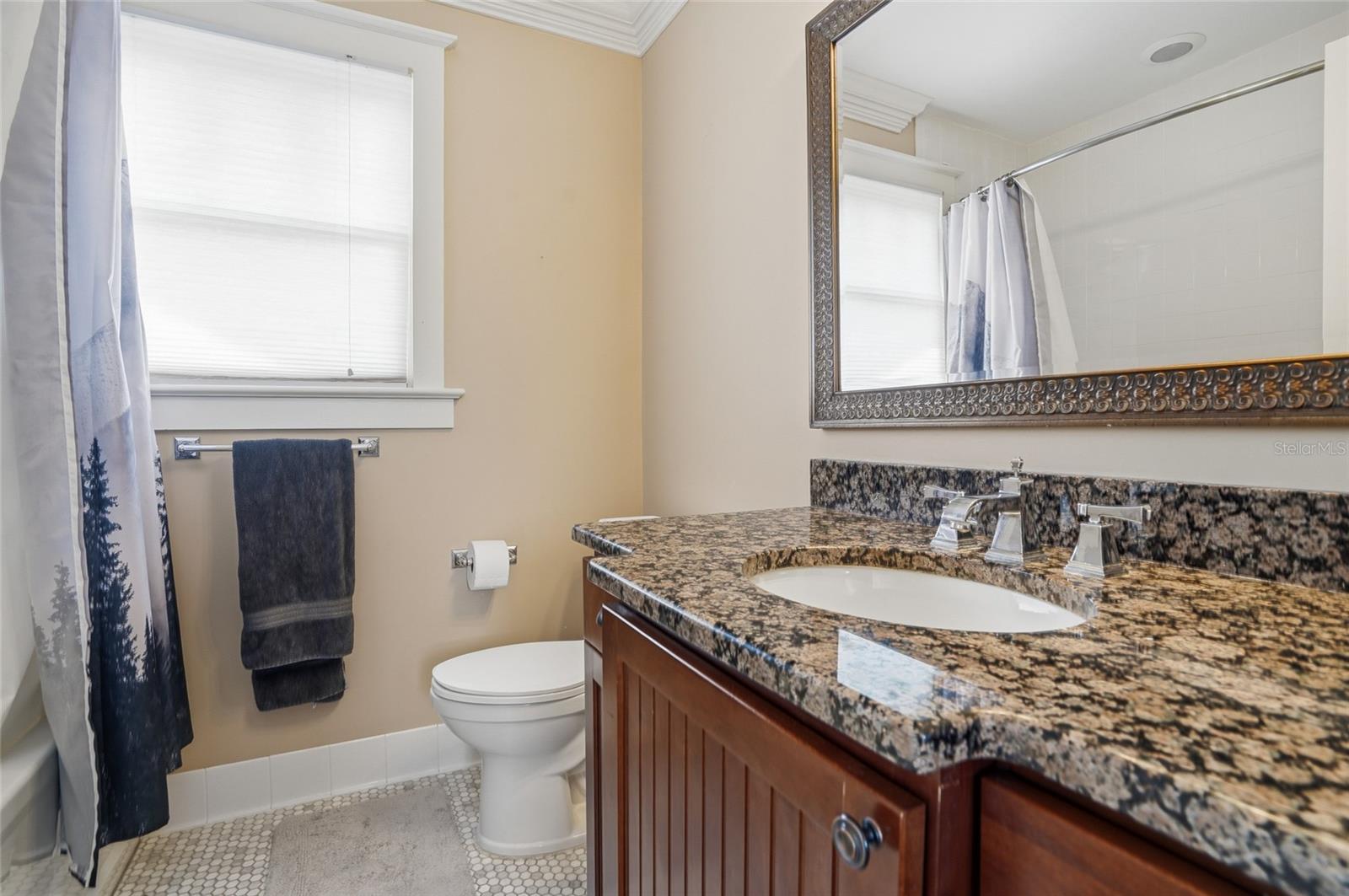 full bathroom with tub and shower in garage apartment