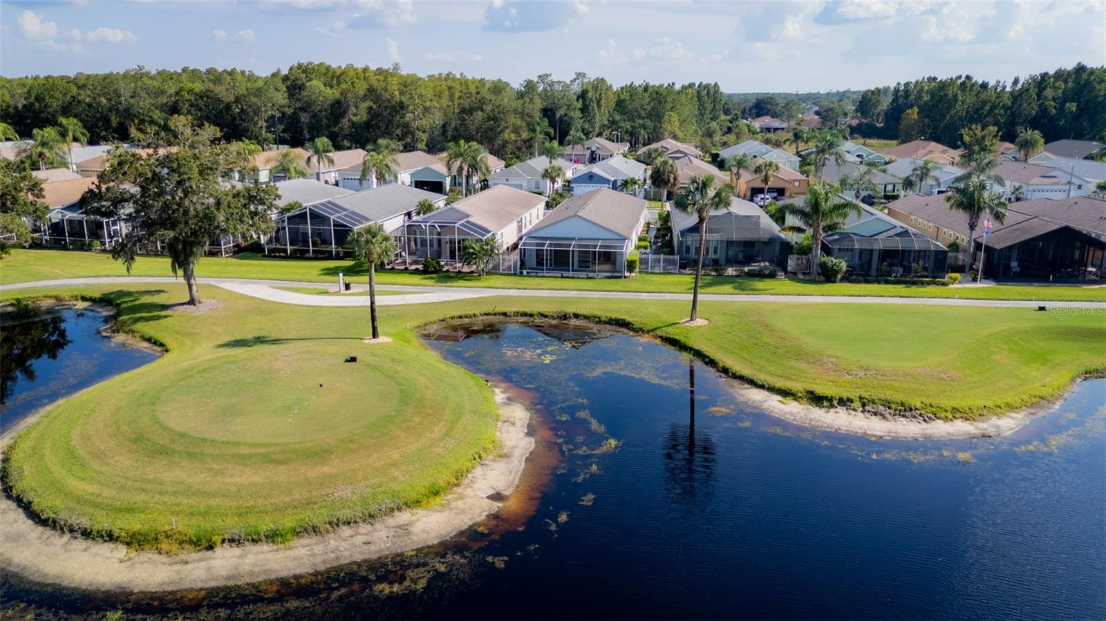 Aerial View Showcasing Golf Course & Water Behind the Home