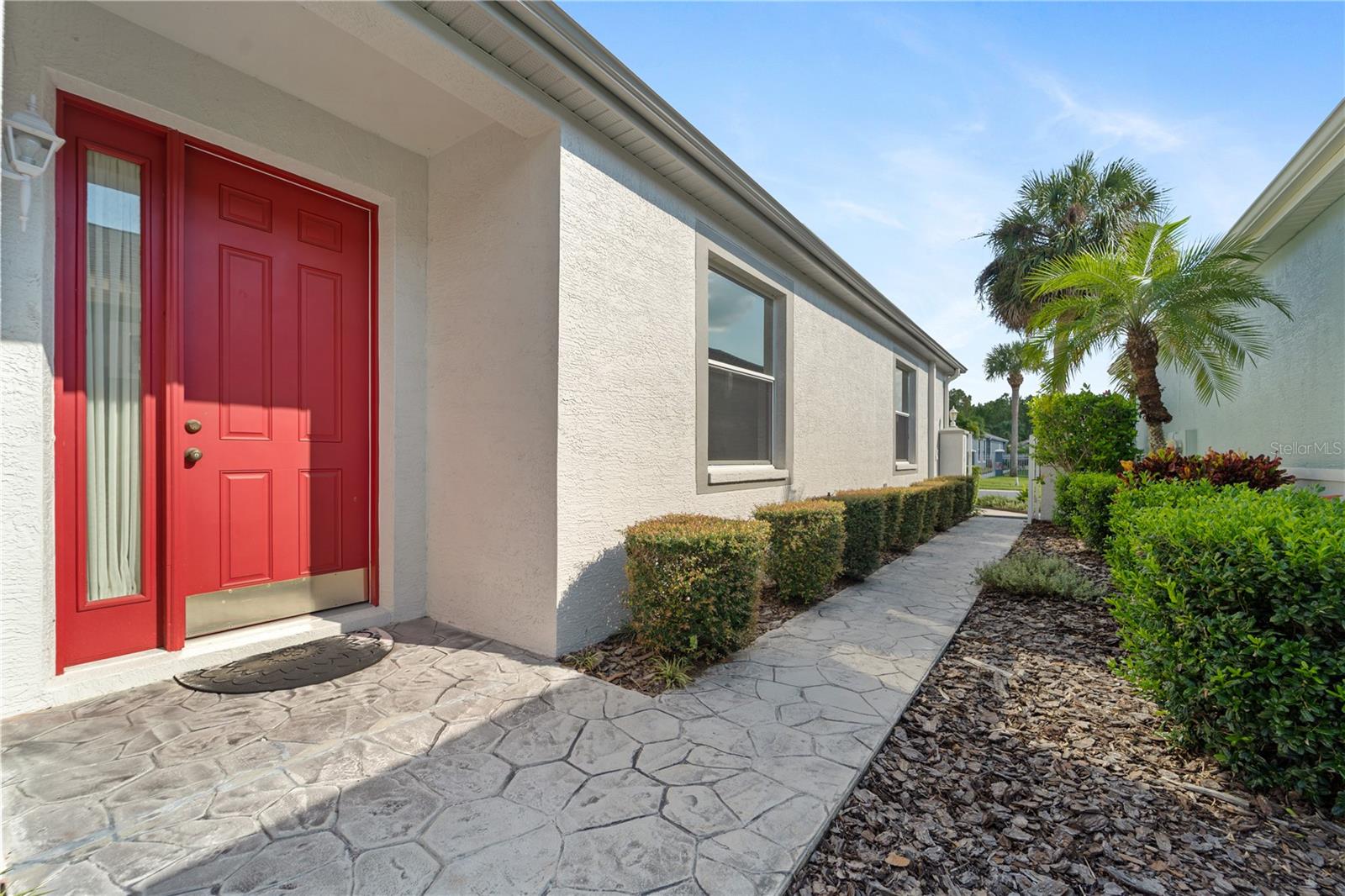 Landscaped Courtyard Entrance with Peek of Water View