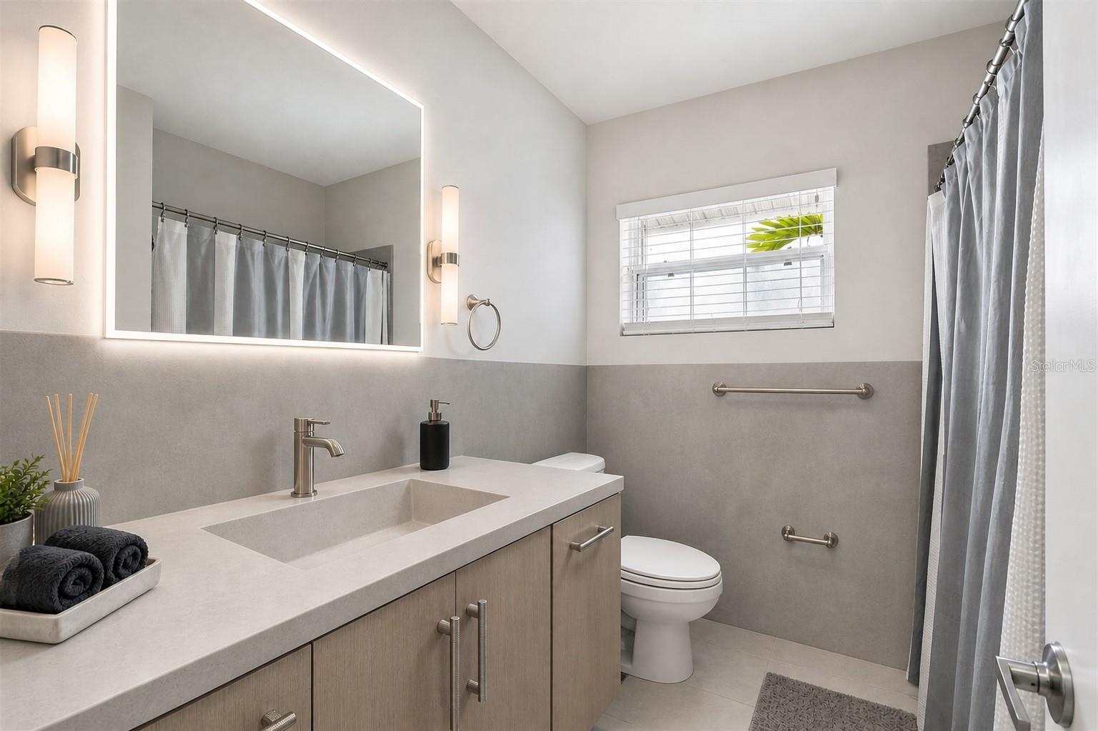 virtualy updated bathroom with microcement finish, new vanity, mirror and sconce