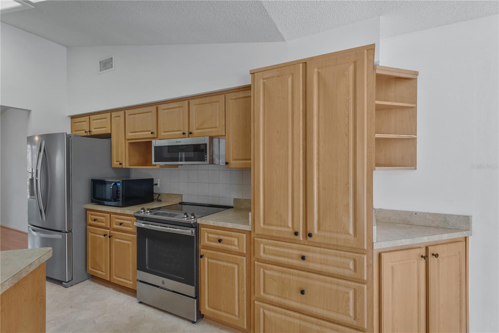 Kitchen offers abundance of upper and lower cabinets for storage.