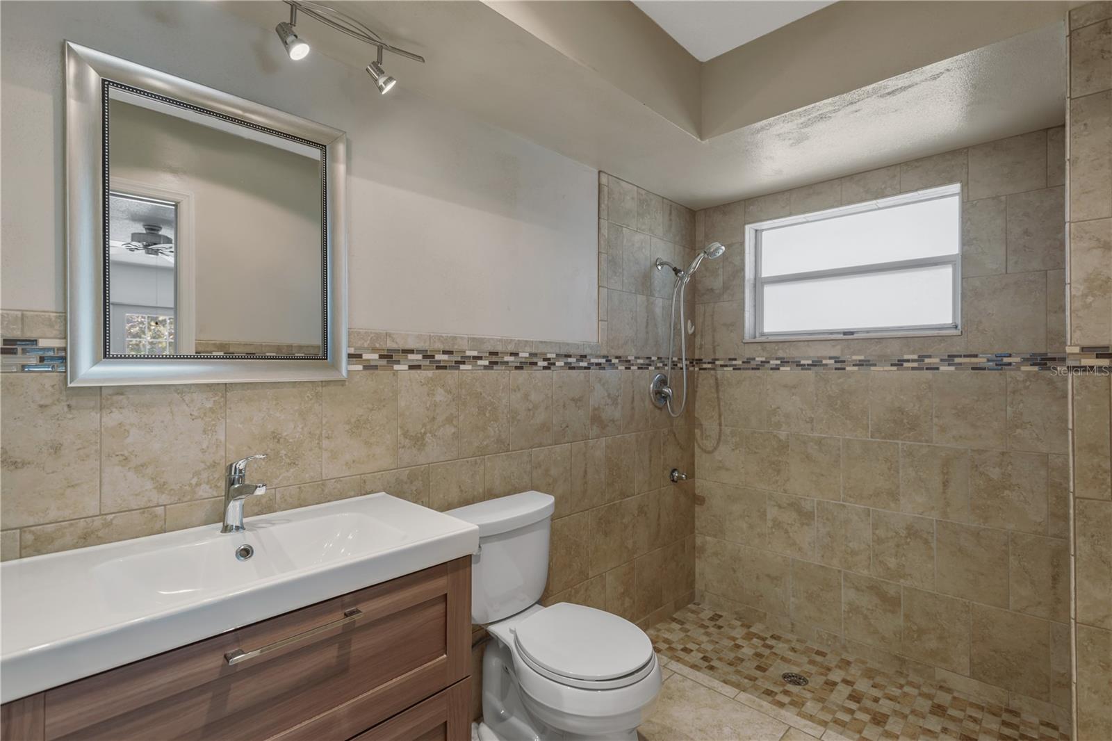 Luxury walk-in, full tile shower with listello accent.