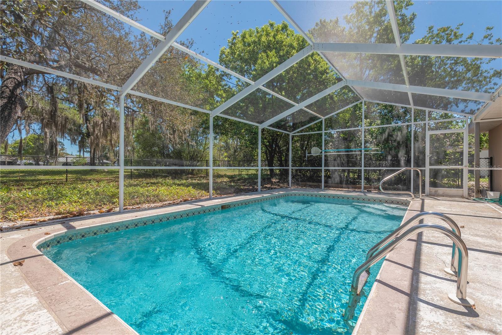Another view of pool and backyard green space.  This home sits on the 6th Fairway of the Golf Course that runs throughout the community.