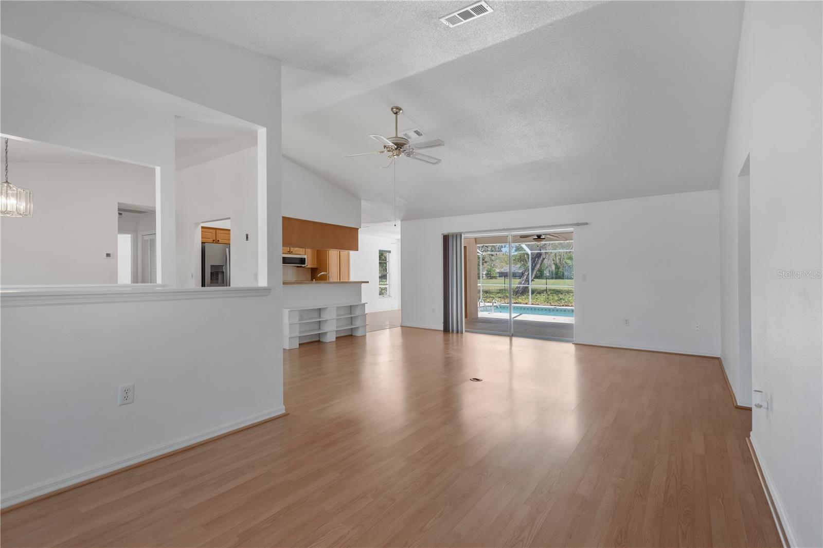 Sitting area / imagination room space leading to open family room and kitchen beyond.