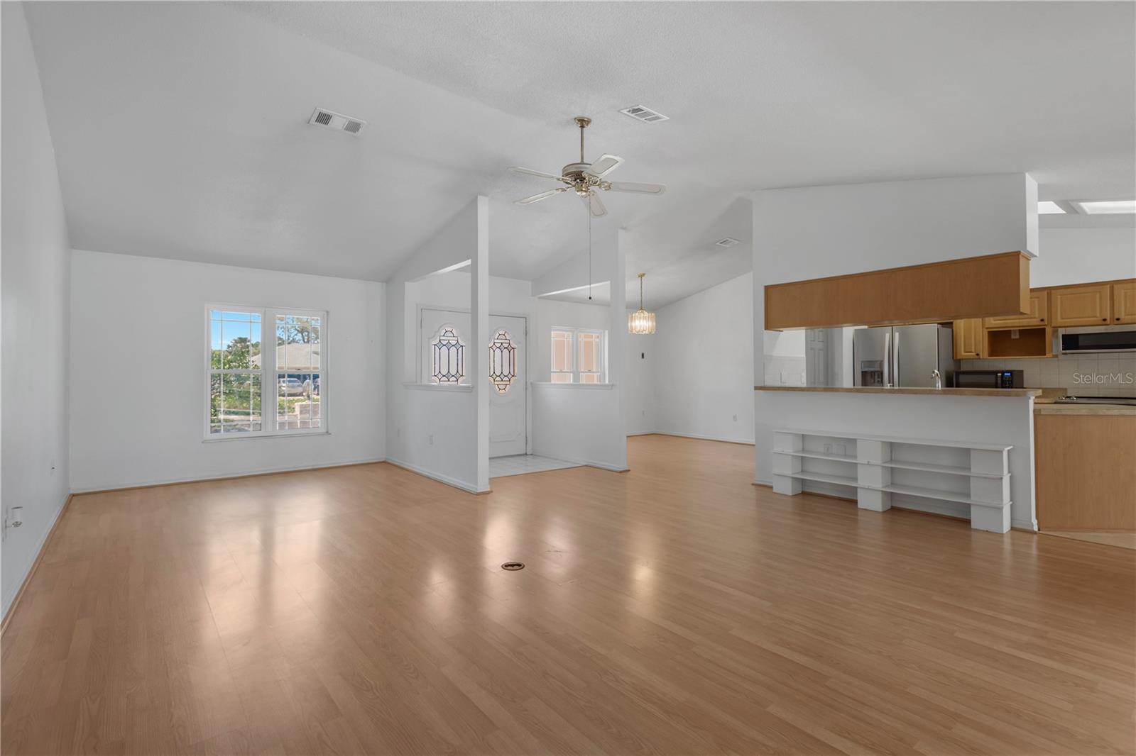 View to grand front entry, formal dining room and sitting area from family room.