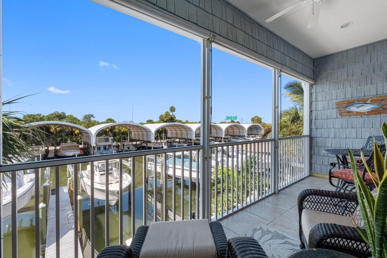 Balcony with a mounted TV and water views.  Enjoy your morning coffee while gazing out at what could be your own ?? boat sitting there waiting for you.