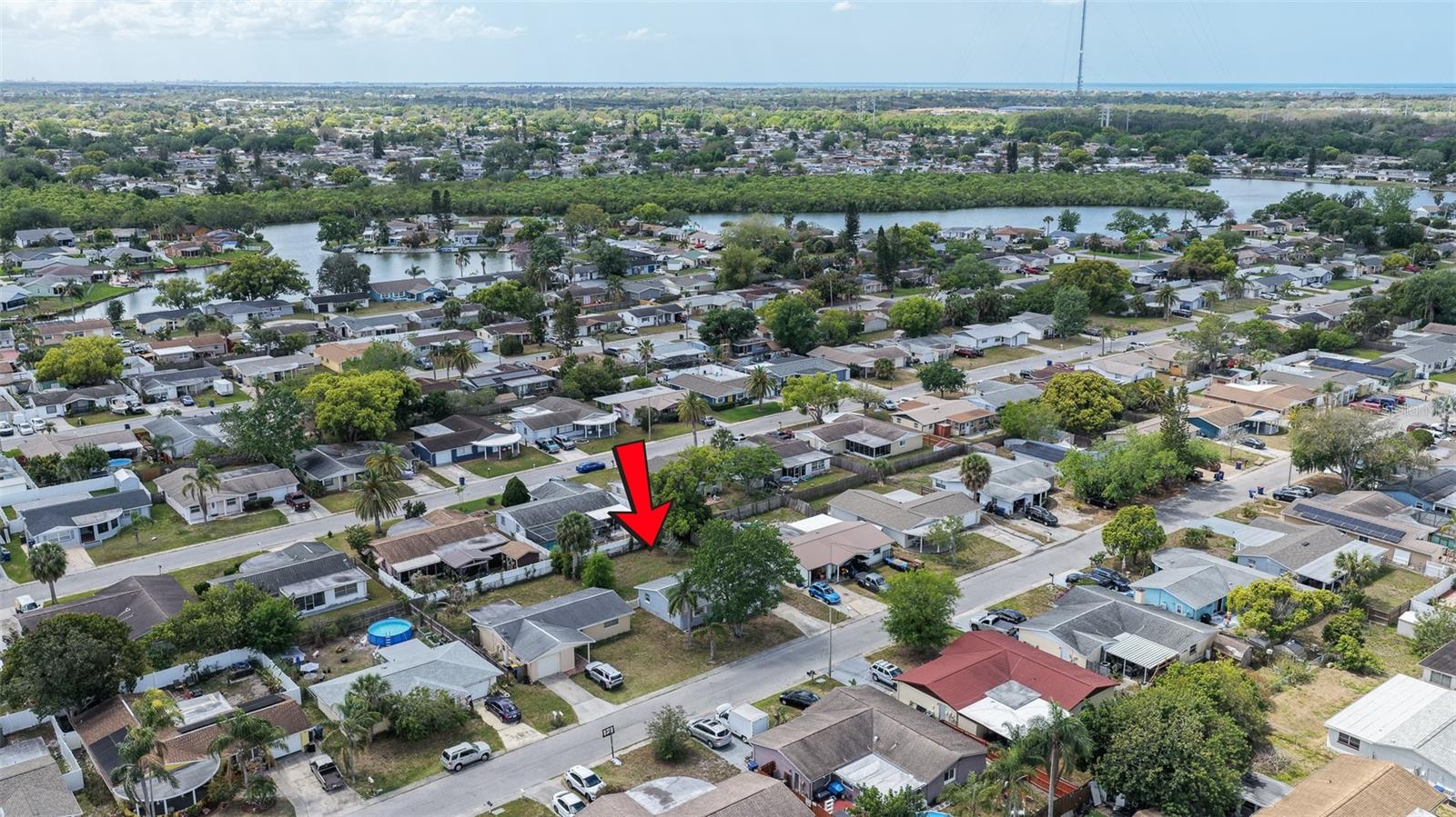 Aerial view showcasing the home’s position in a quiet Holiday neighborhood with easy access to major roads.