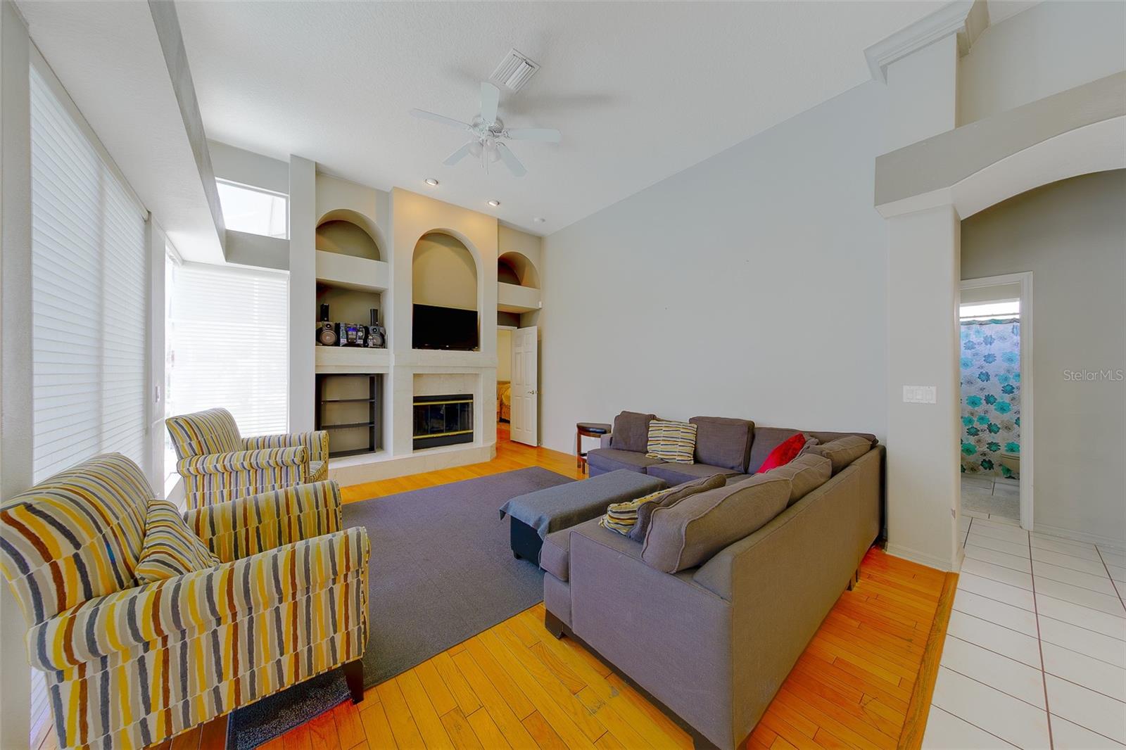 Light and bright family room with plenty of windows for natural light and wood burning fireplace