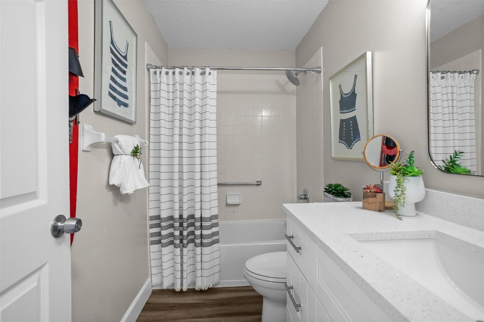 Guest bath showing tub and new vanity