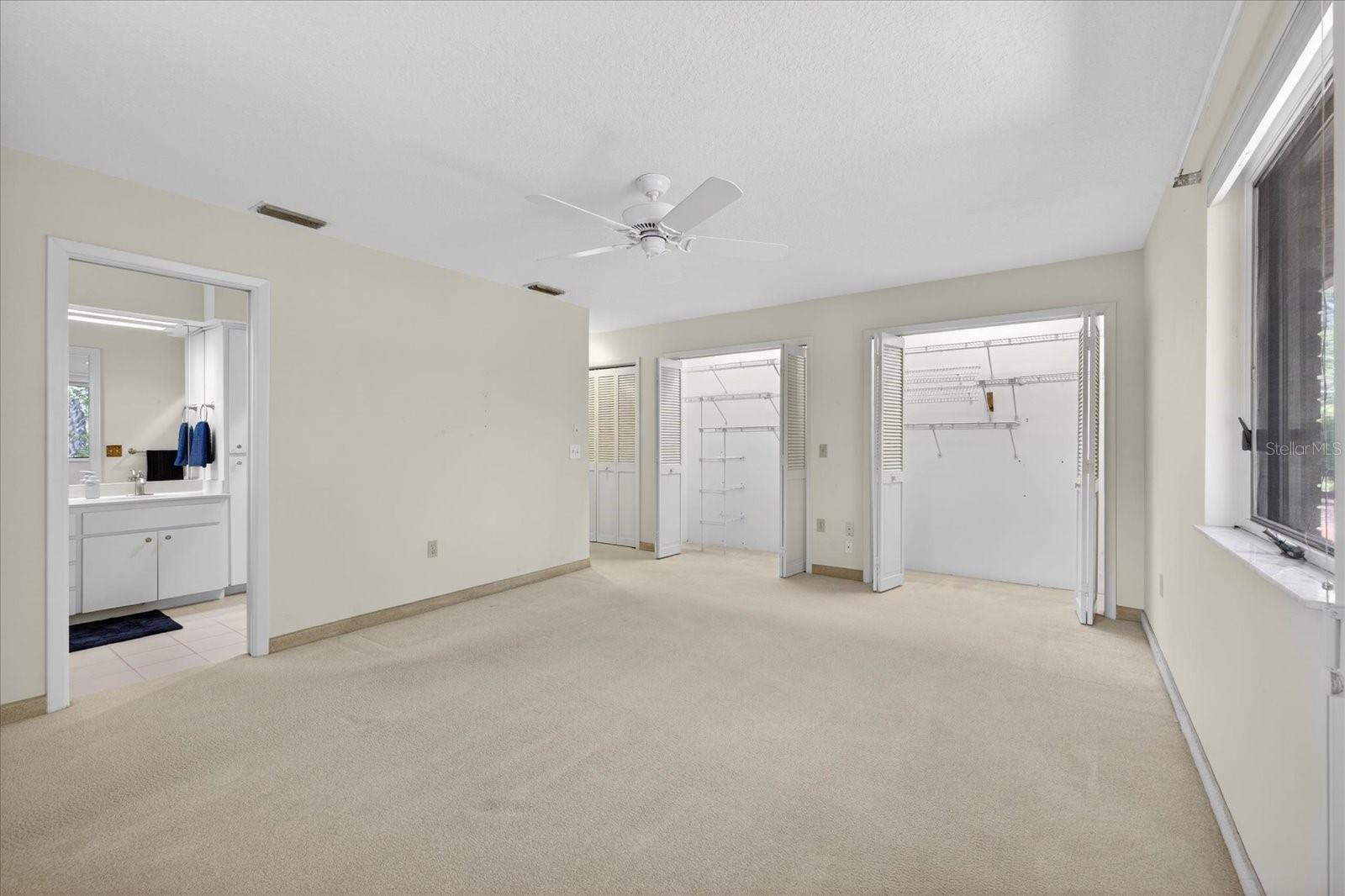 Primary bedroom with multiple closets
