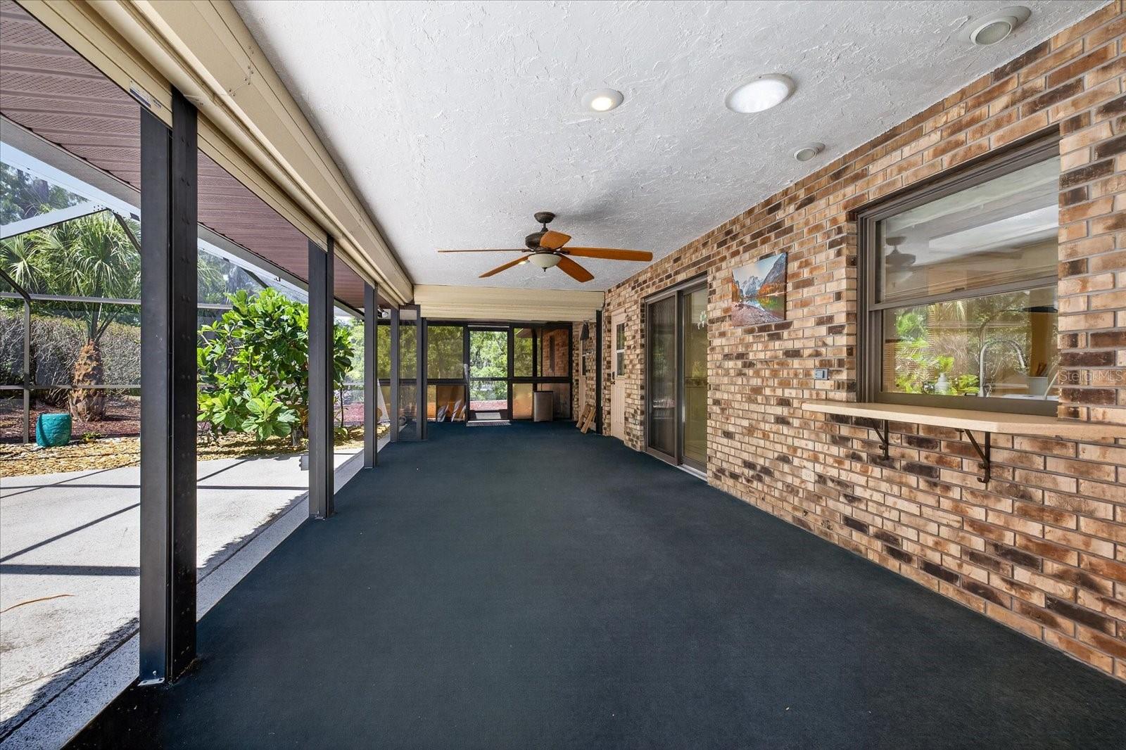 covered rear patio with hurricane shutters