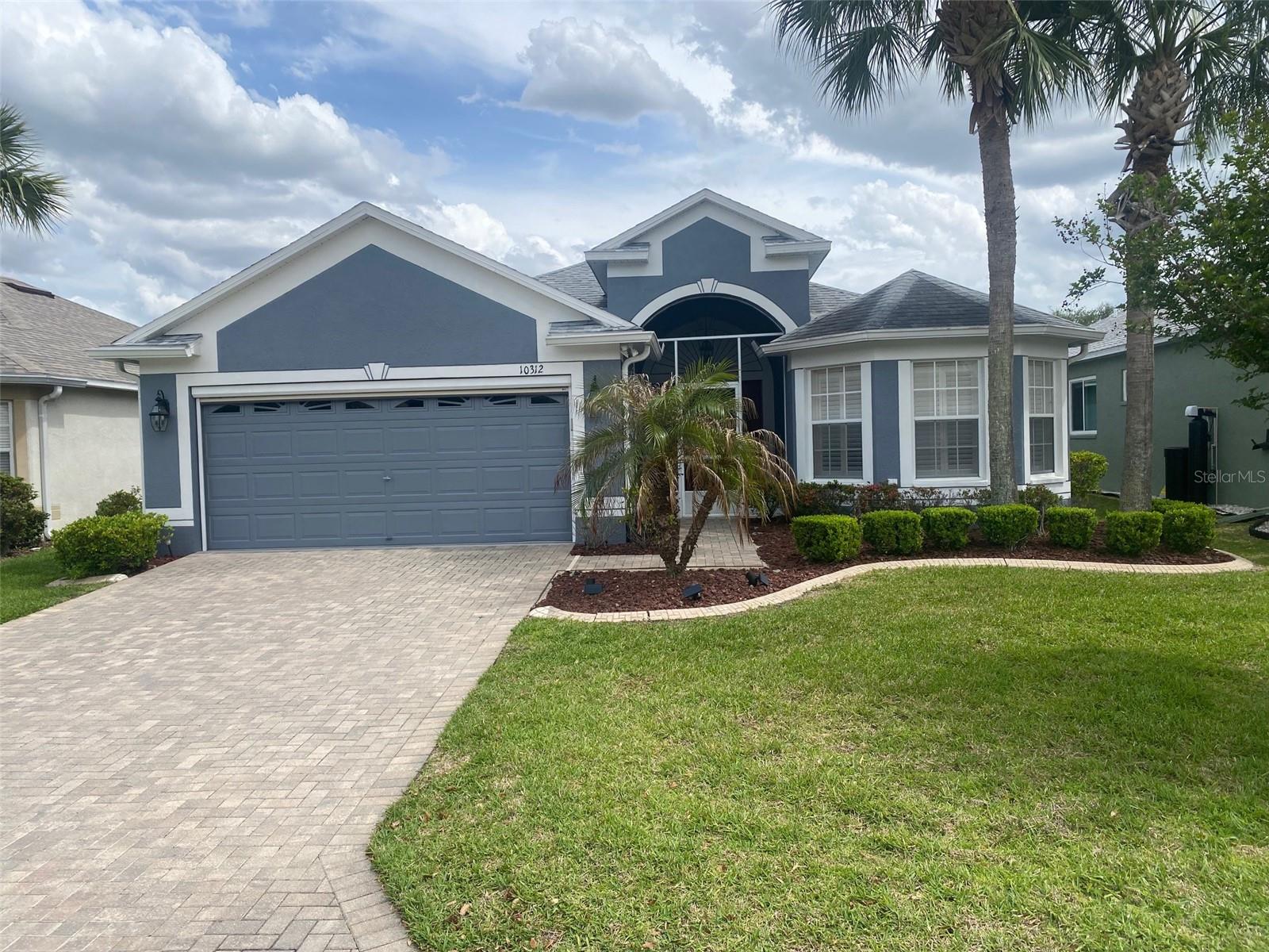 Great curb appeal and an amazing paver driveway.
