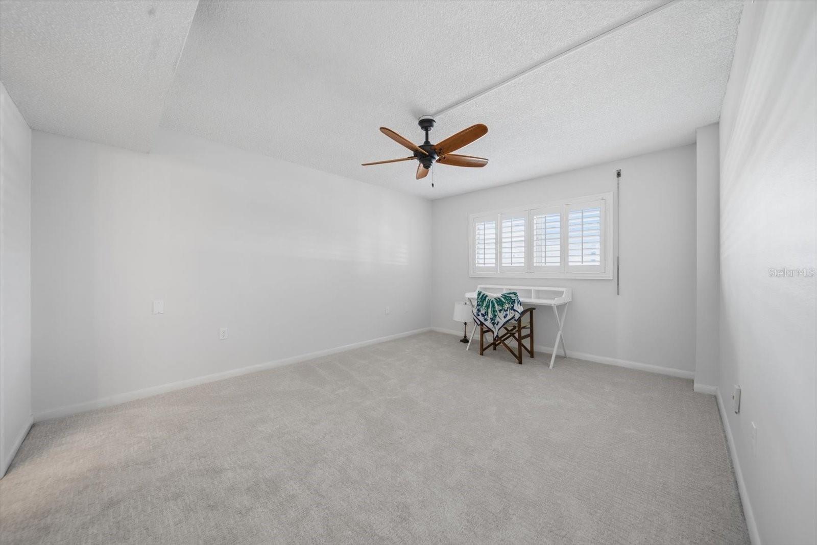 The bedroom features hurricane shutters and en-suite bathoom.