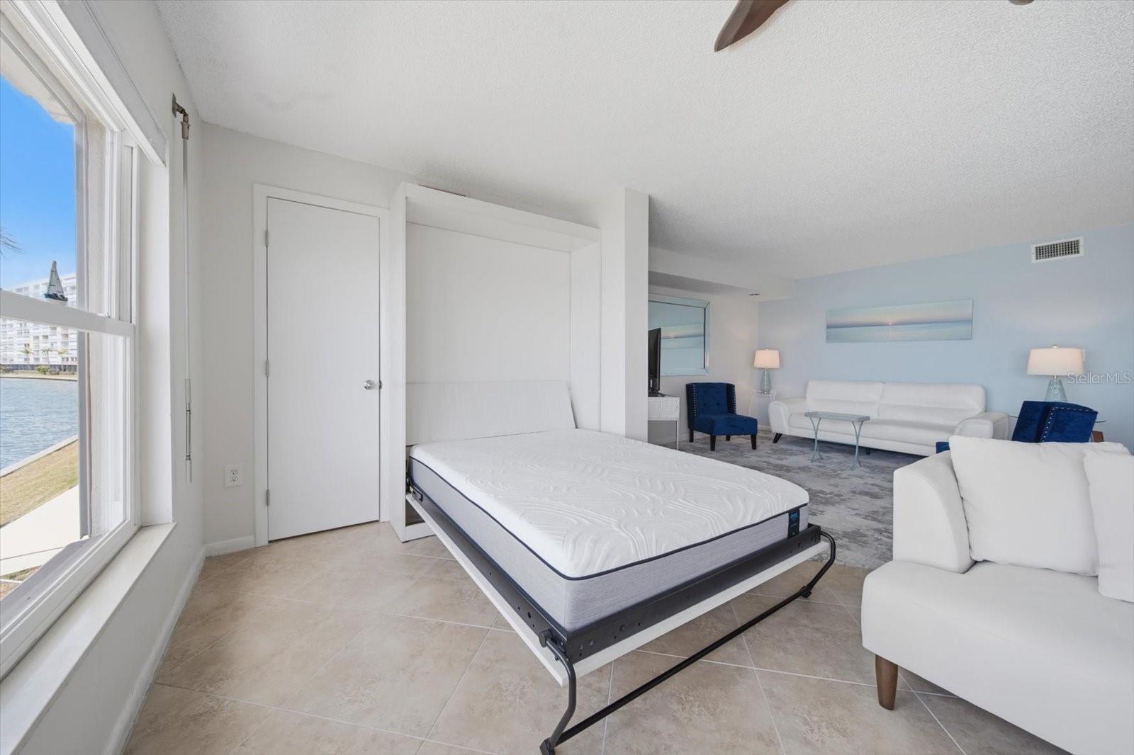 A hidden Murphy bed with midnight views of the water is a wonderful luxury for overnight guests.