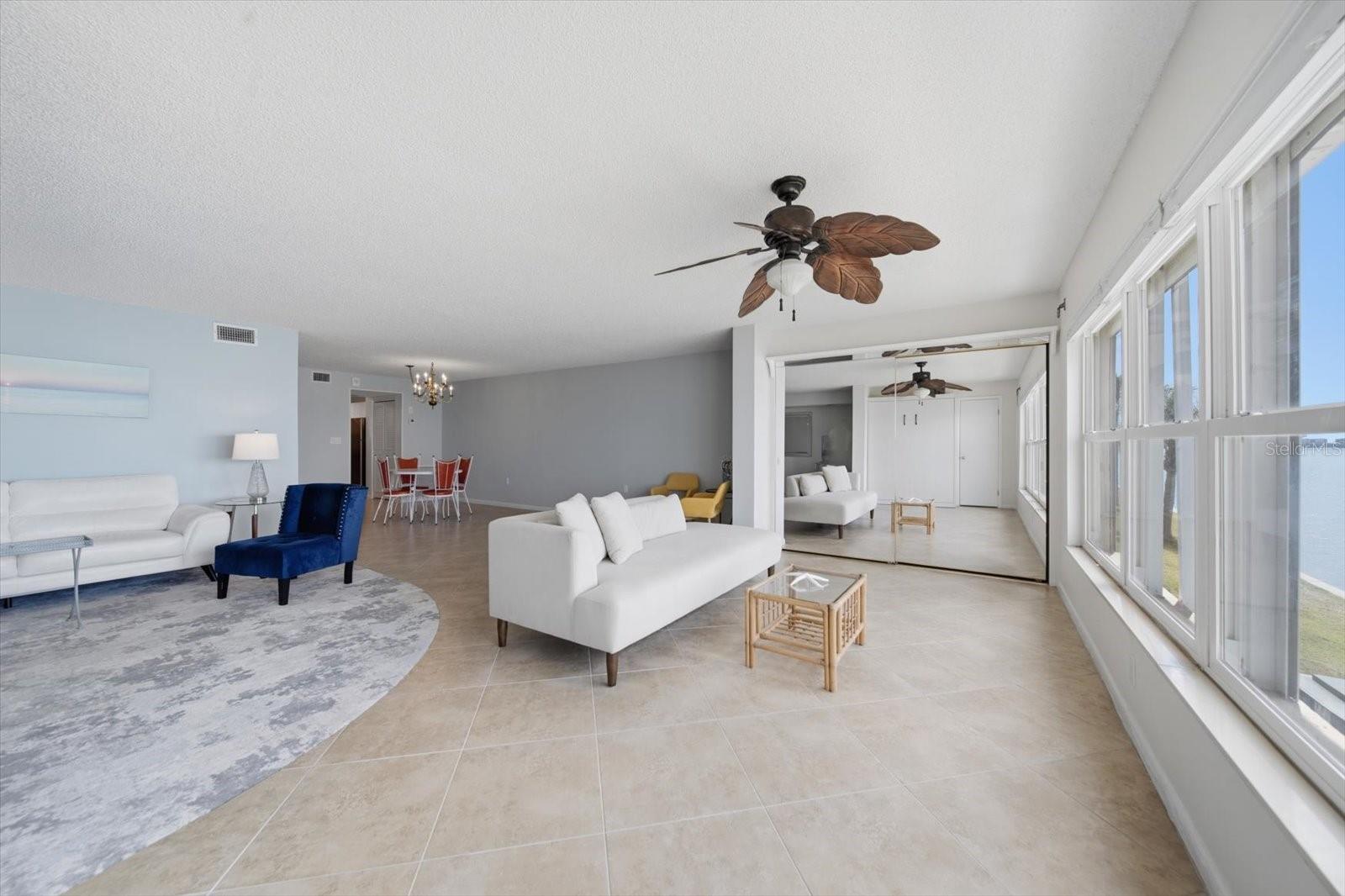 Mirrored sliding doors conceal a large wall closet that provides additional storage space.