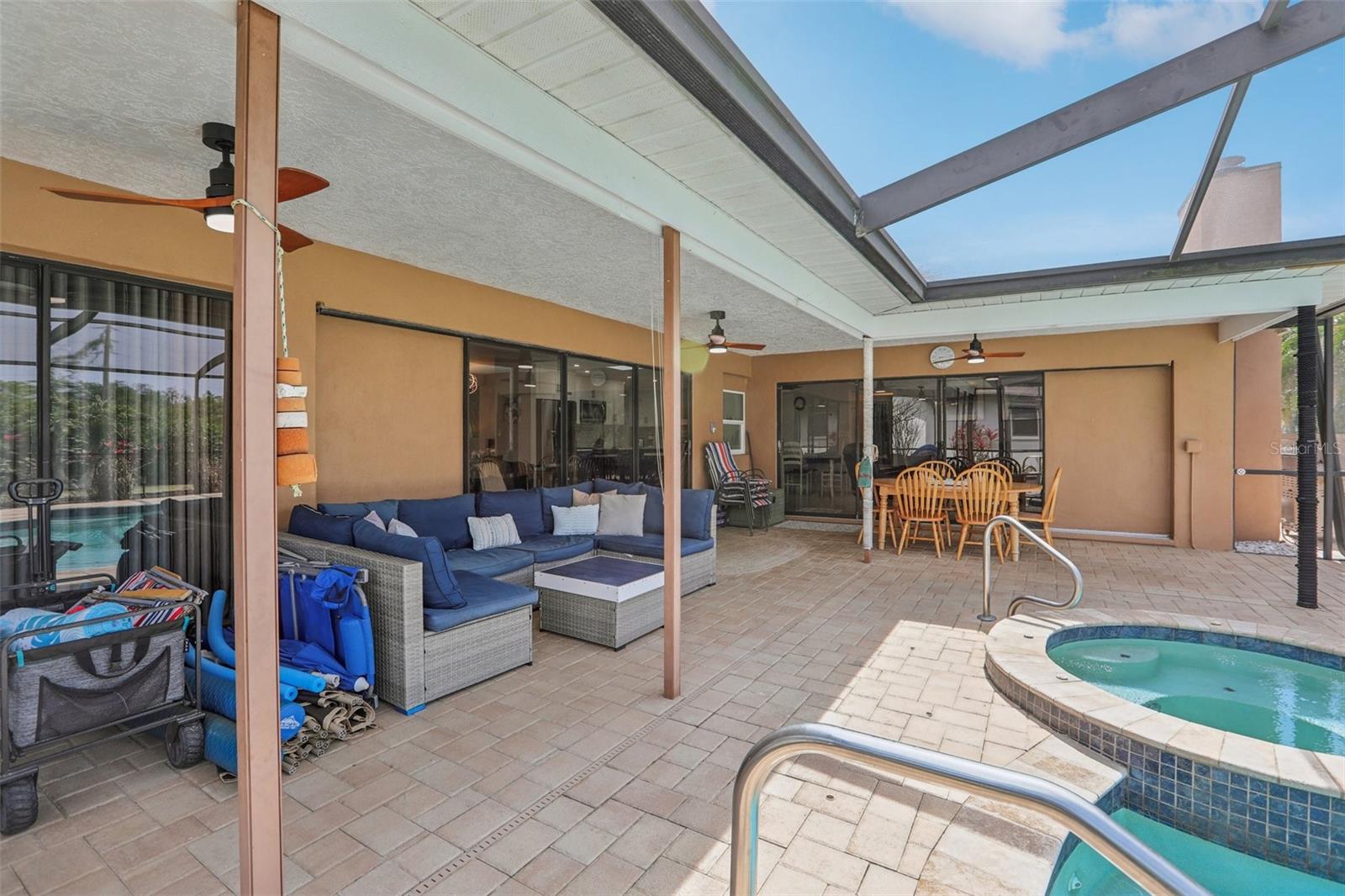 Your spacious lanai where you can sit and relax, swim, soak in the spa or dine alfresco.3 sets of sliders open to the Primary Bedroom, Family Room and Living Room (L-R).