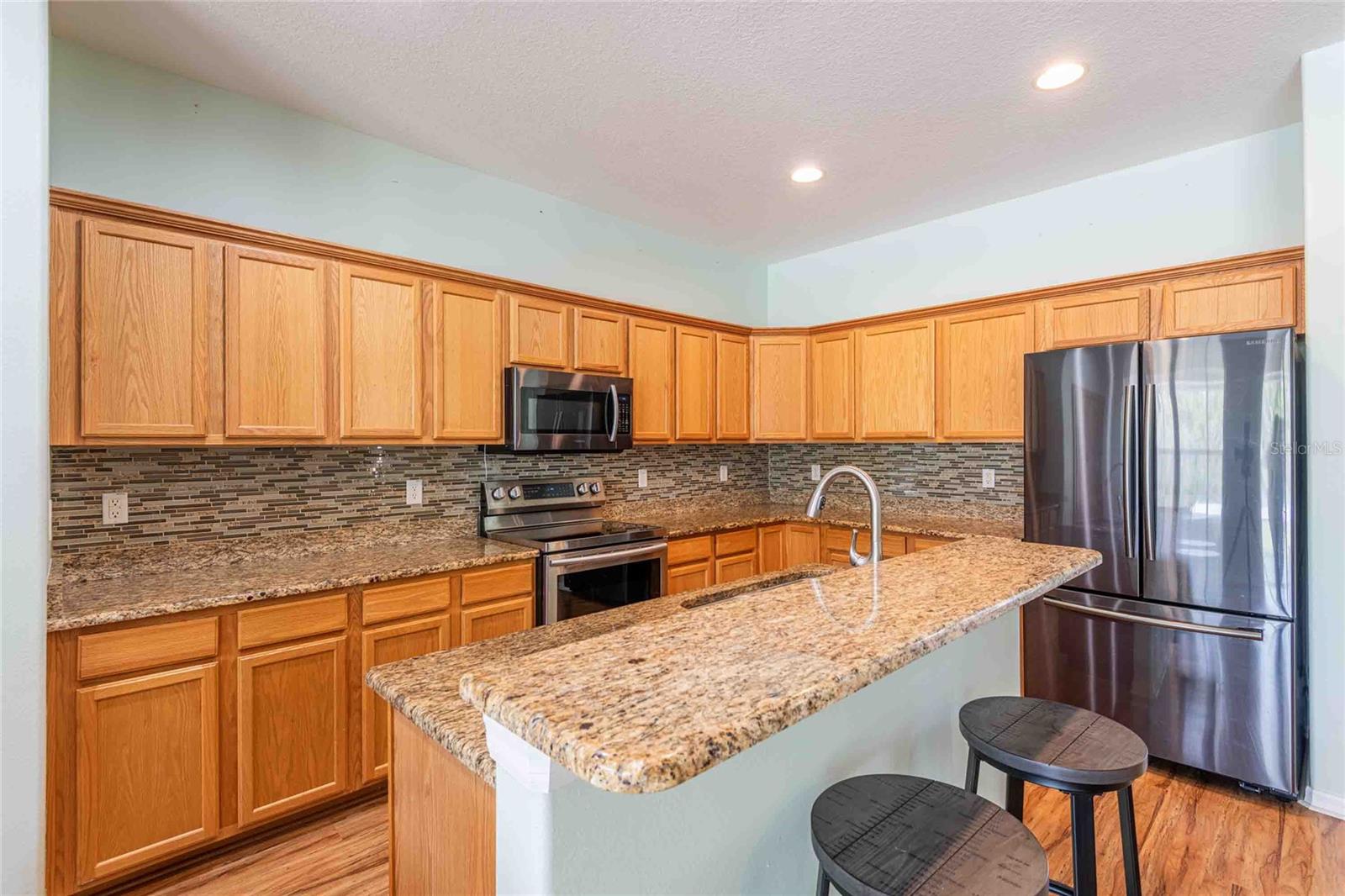 Granite counters and wood cabinets.