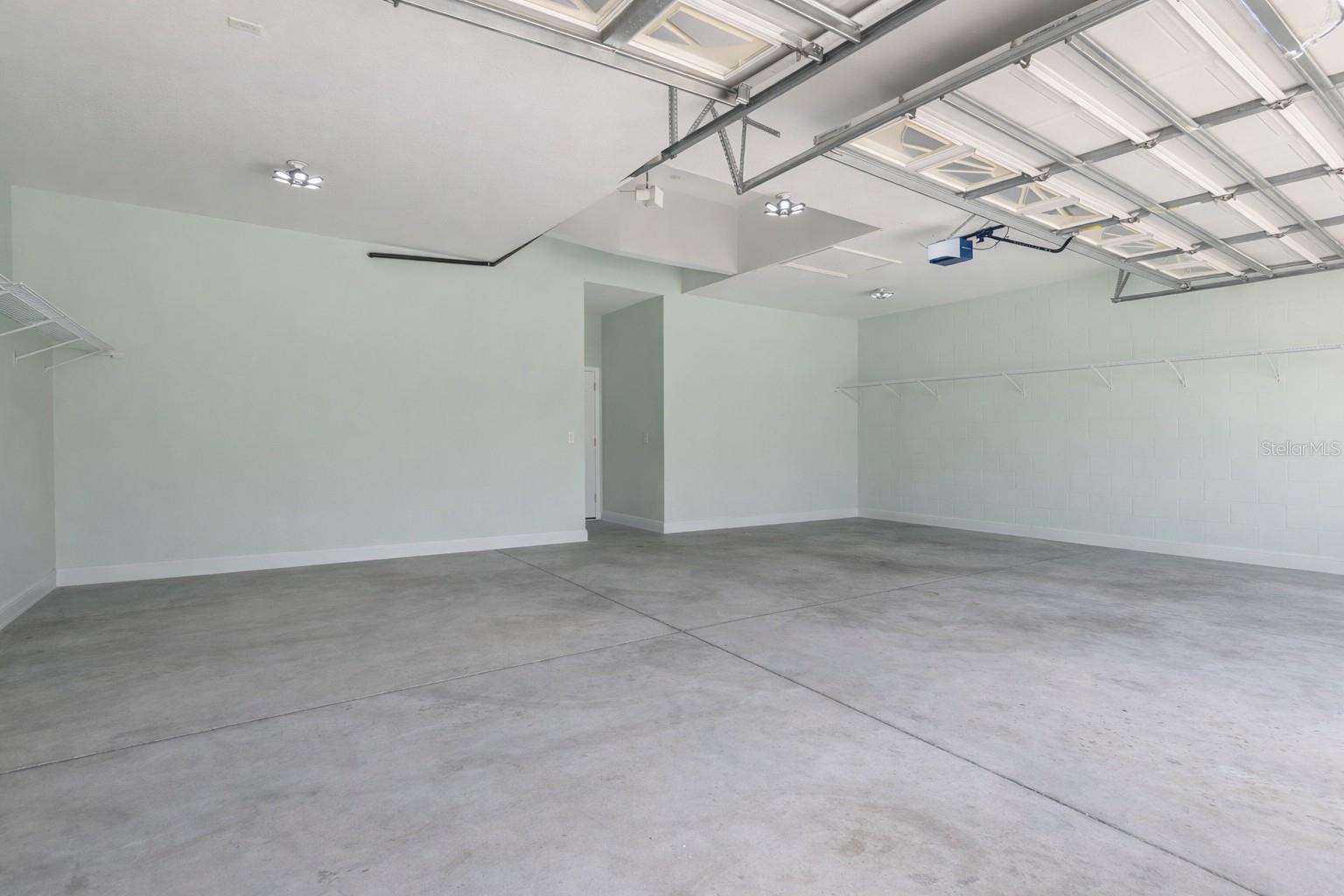 Spacious 3 car garage with items virtually removed.