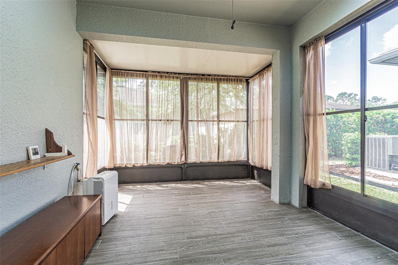 Beautiful lanai with premium Vinyl Planking.