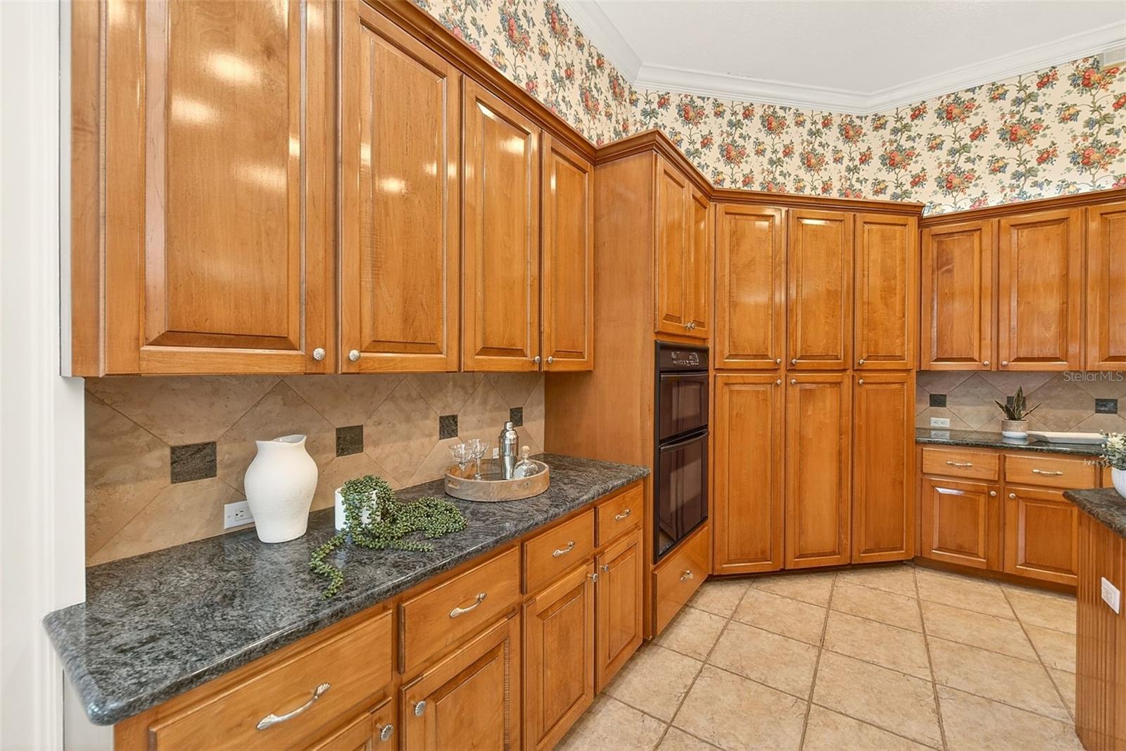 Granite countertops and wall oven and microwave.
