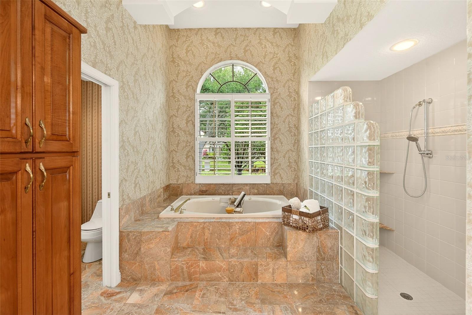Jetted tub with separate walk-in shower.