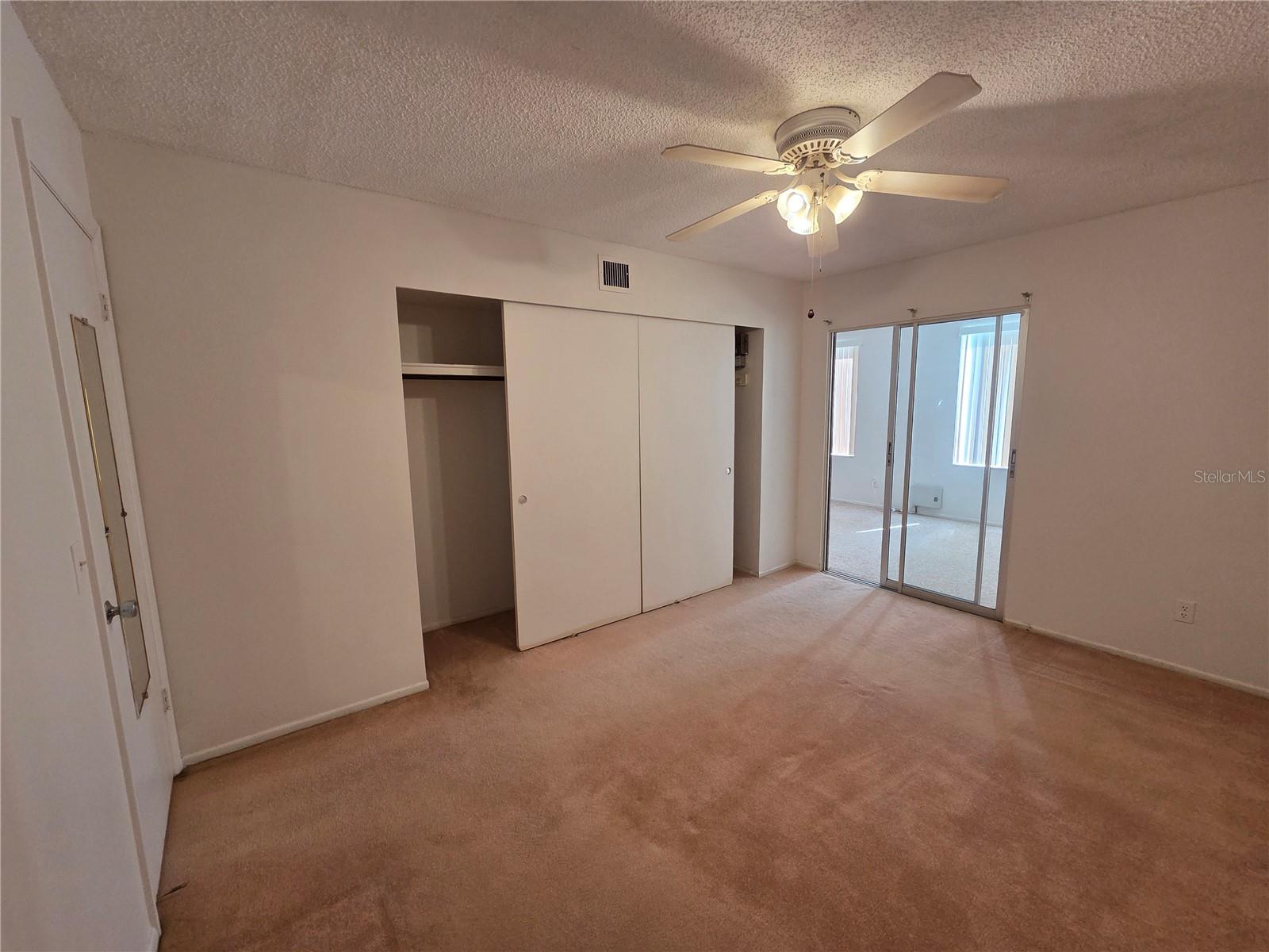 Wall of closets in Primary bedroom - slider takes you to the Family room/Florida Room