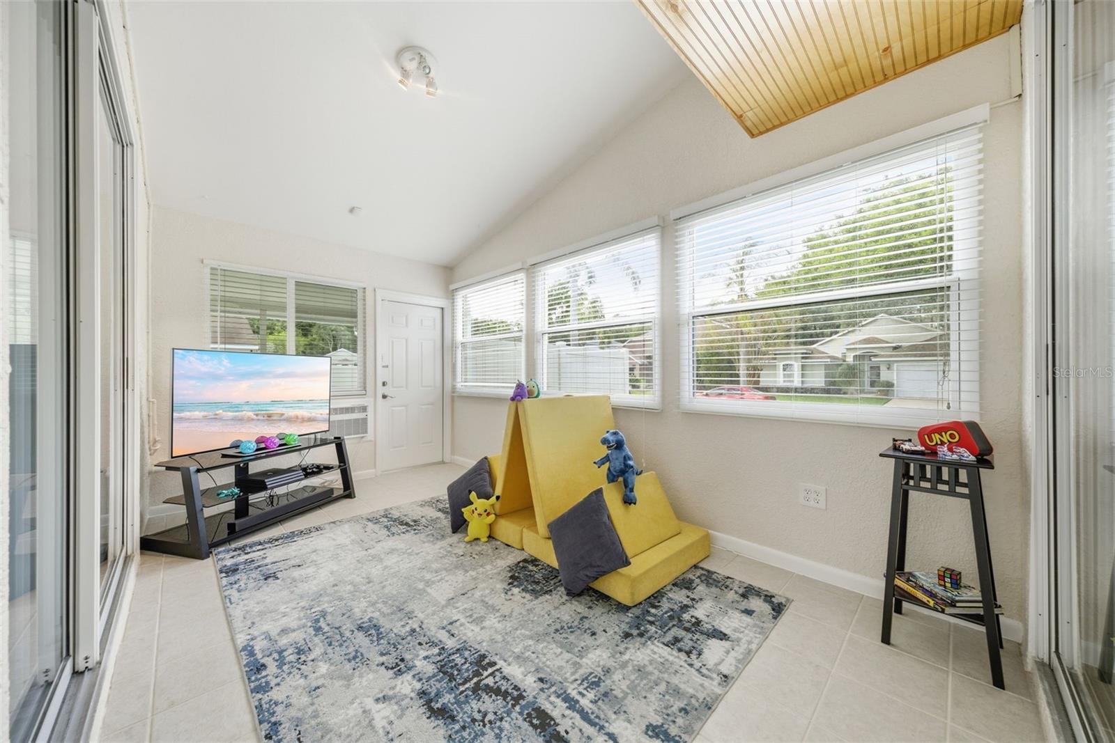 family room opens to a fully enclosed bonus space