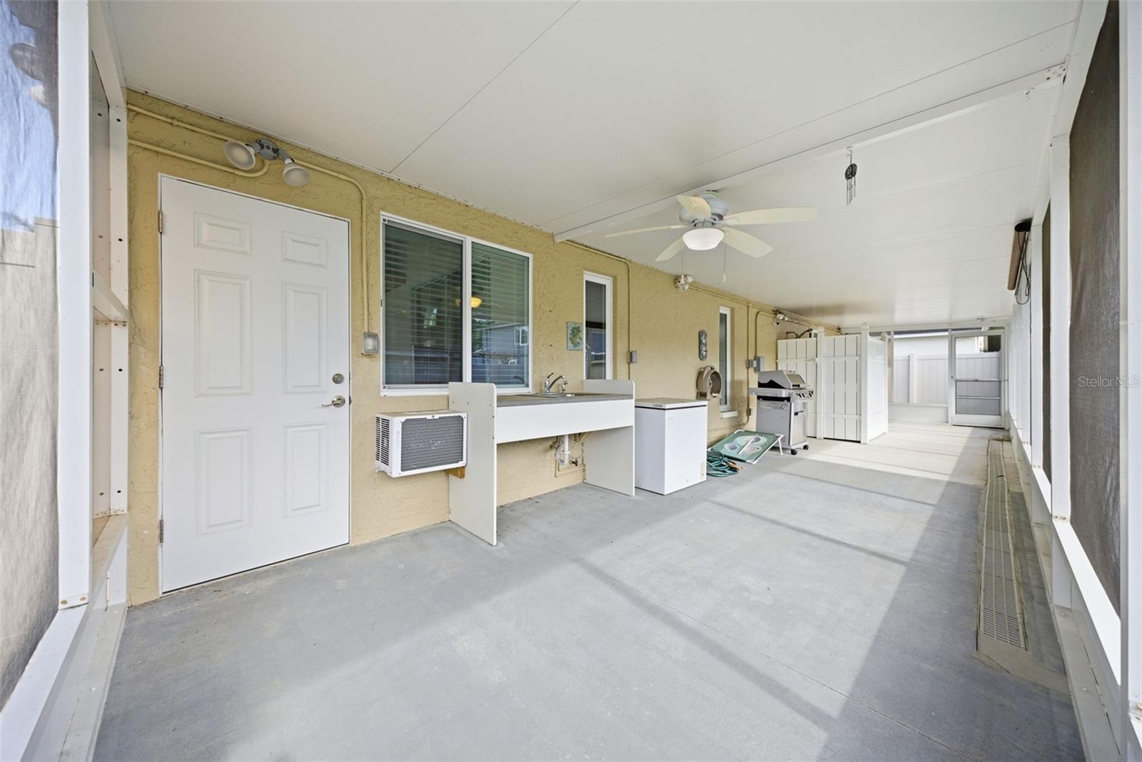 Screened back patio with plumbing for outdoor kitchen