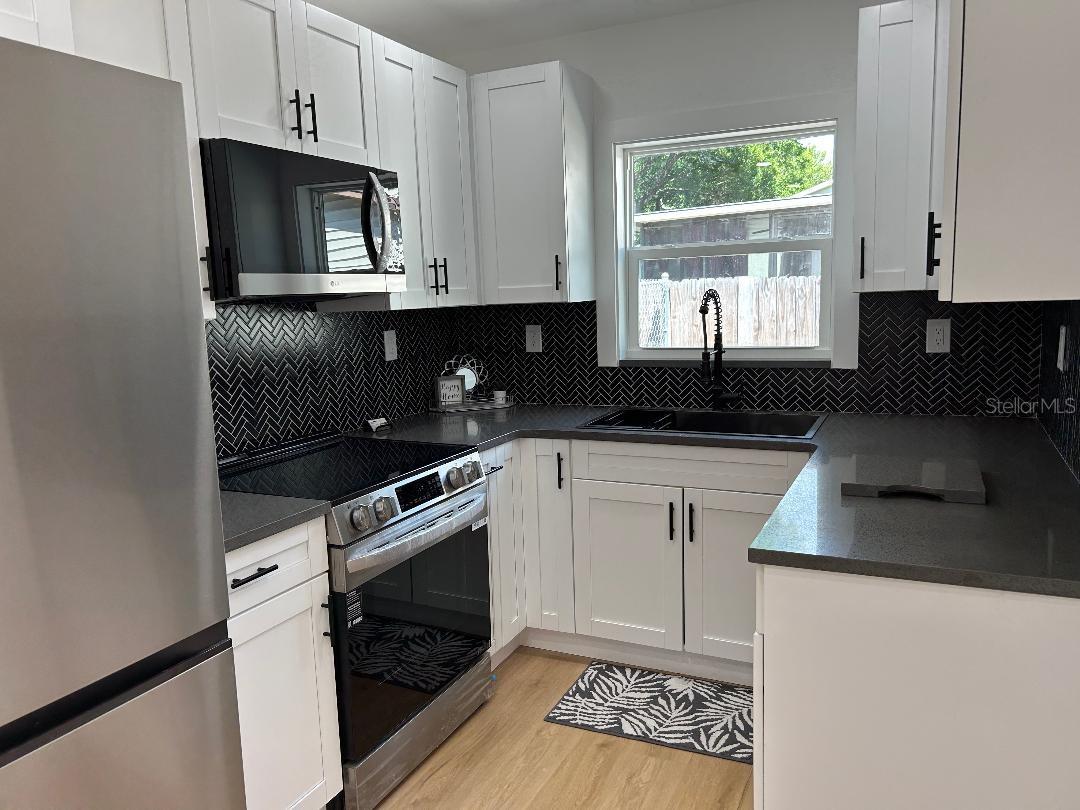 Gorgeous kitchen has built-in spice rack & large corner cabinet