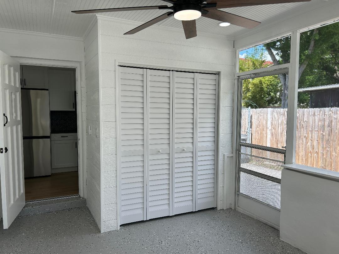 Attached screened porch with laundry, entry to kitchen closet, large fan