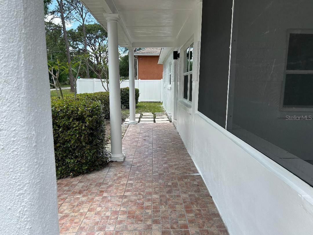 Entryway with front enclosed porch, tiled entry; room for seating