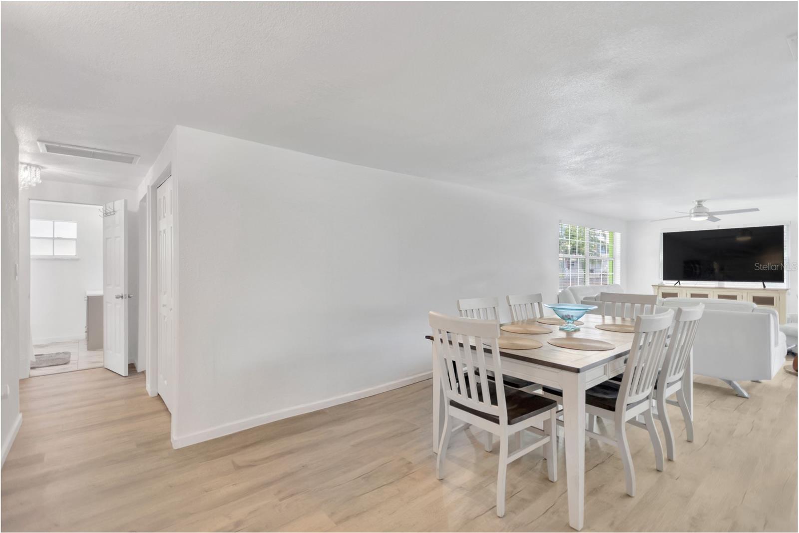 Looking from the dining area into the Living Room.  Blank wall space provides an opportunity to showcase your favorite artwork or enhance with the perfect dining room Hutch to complete the "Look".
