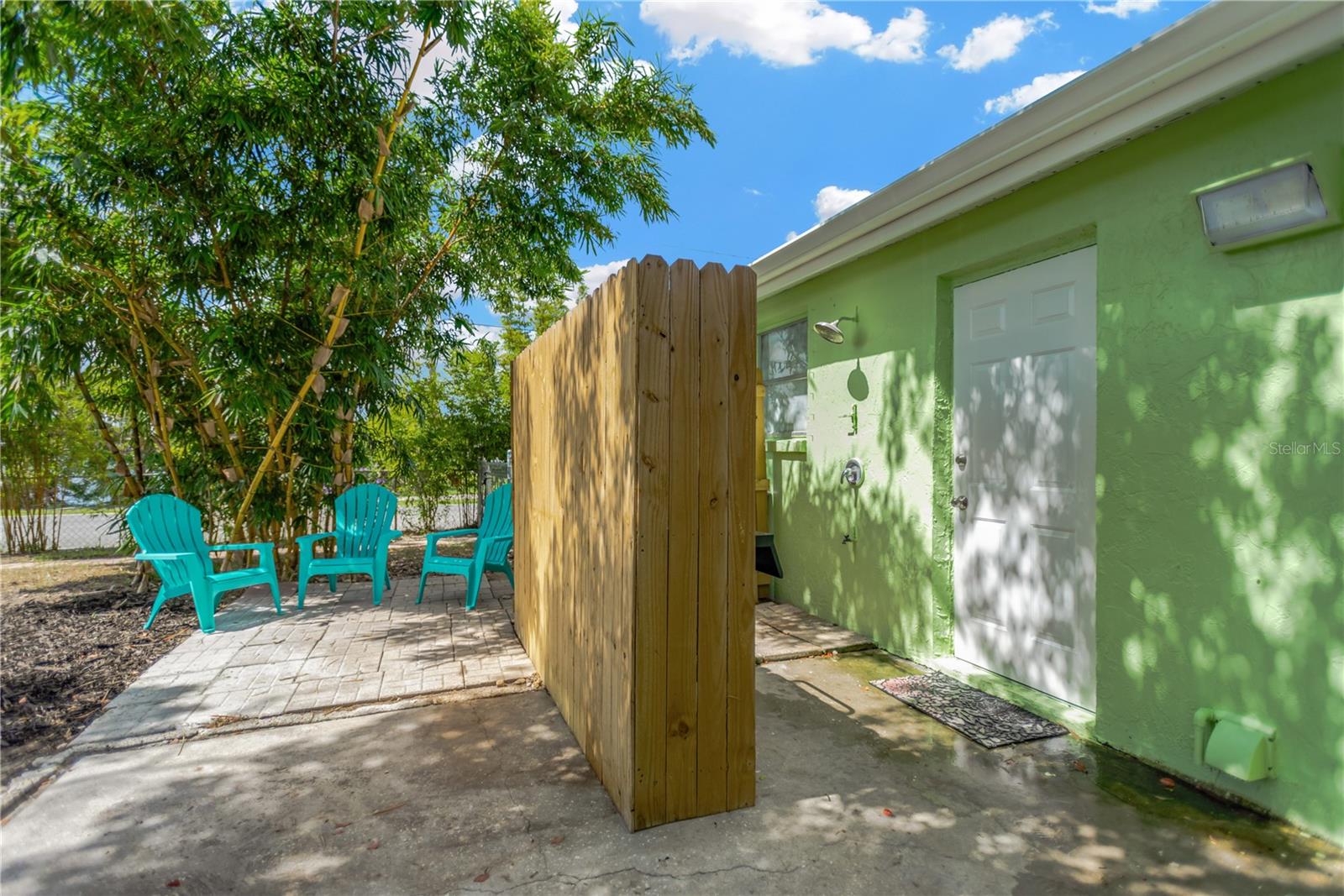Backyard offers a private outdoor shower area.