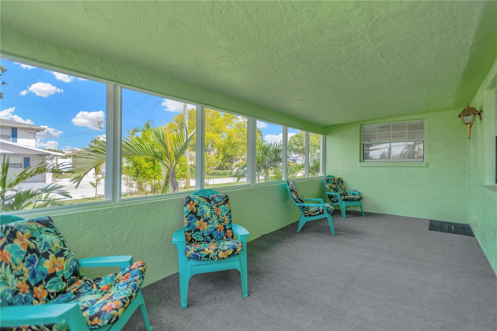 Another view of this spacious front porch/Florida Room which can accomodate fun furniture for the coastal lifestyle, casual environment.