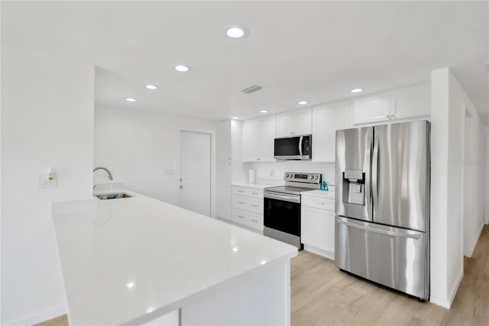 Sparkle Quartz countertops make this kitchen shine with elegance.  New LG appliances complete this dream kitchen.