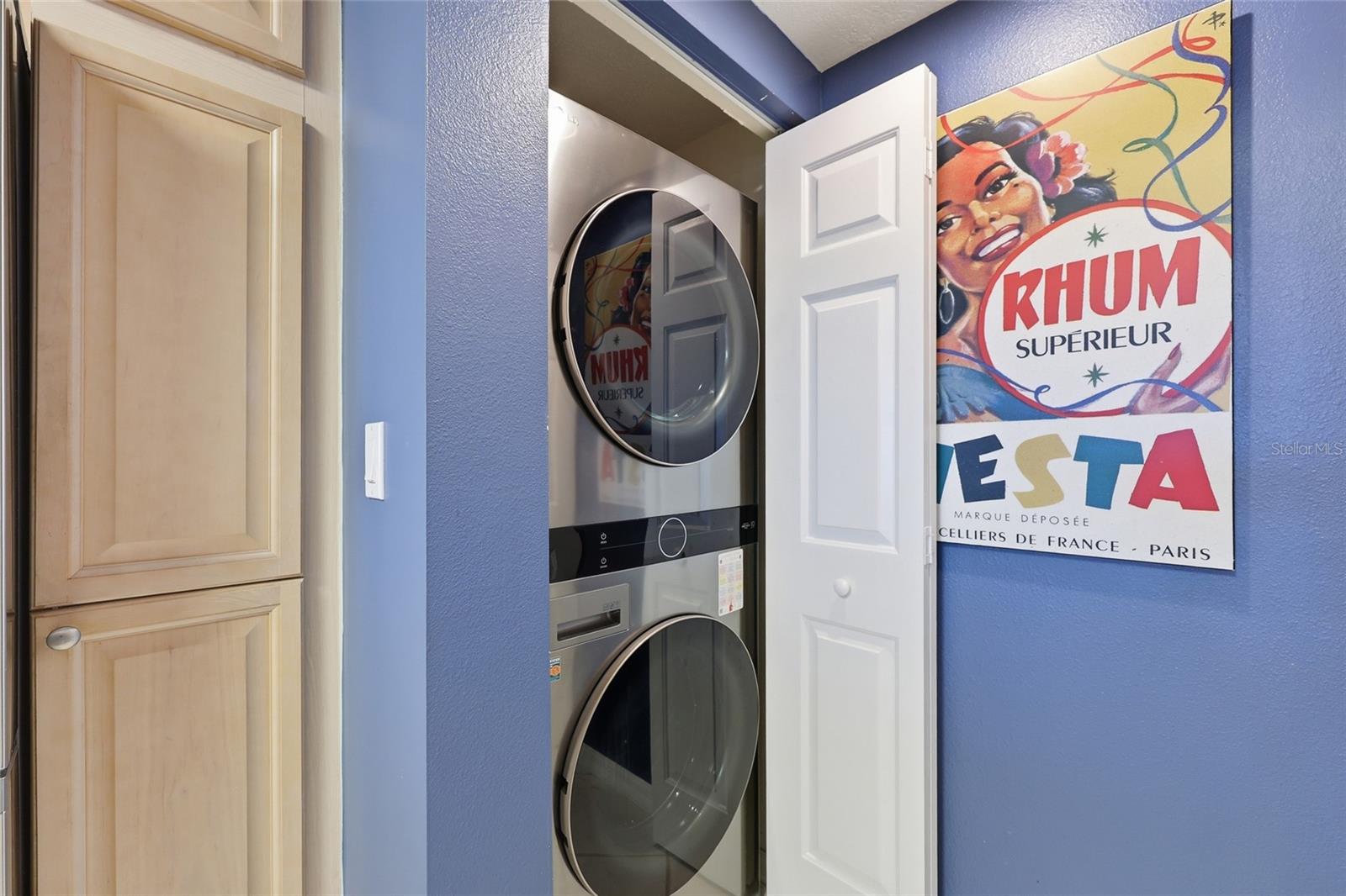 Full sized stacked LG washer/dryer off the kitchen