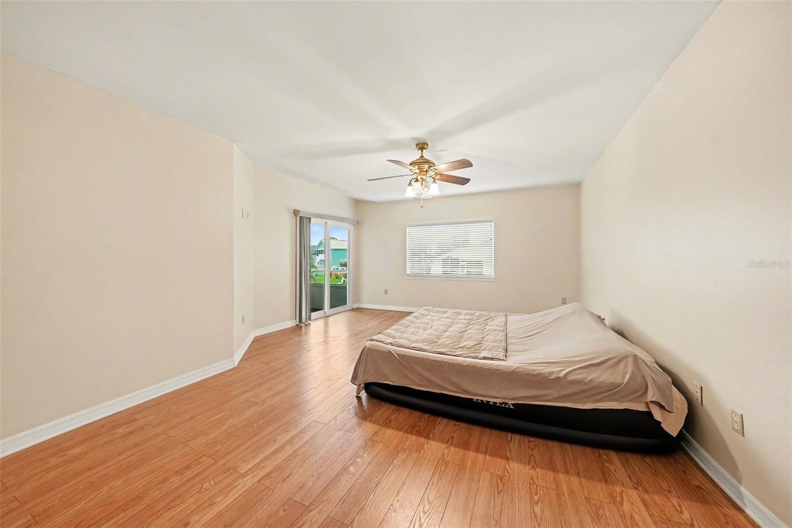 Master bedroom with hurricane sliders opening to the screened patio.