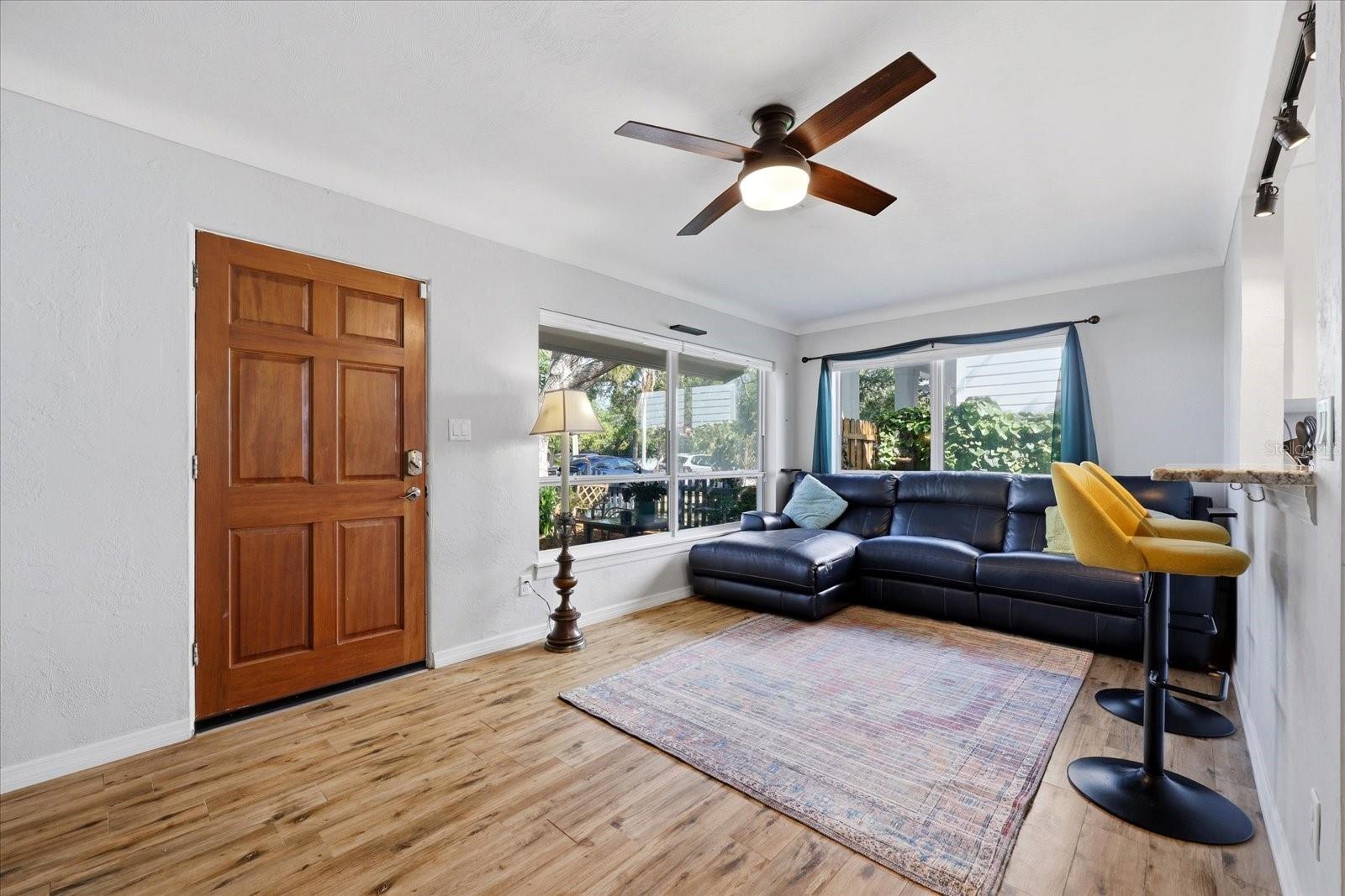 Bright living area with natural light and view toward front entry