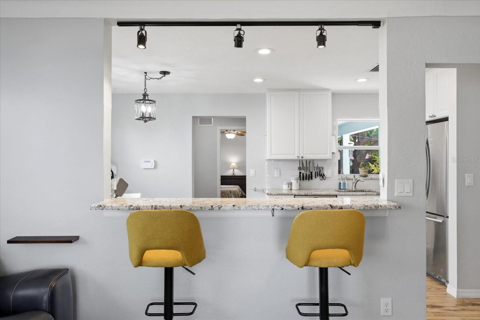 Breakfast bar seating with open view into kitchen