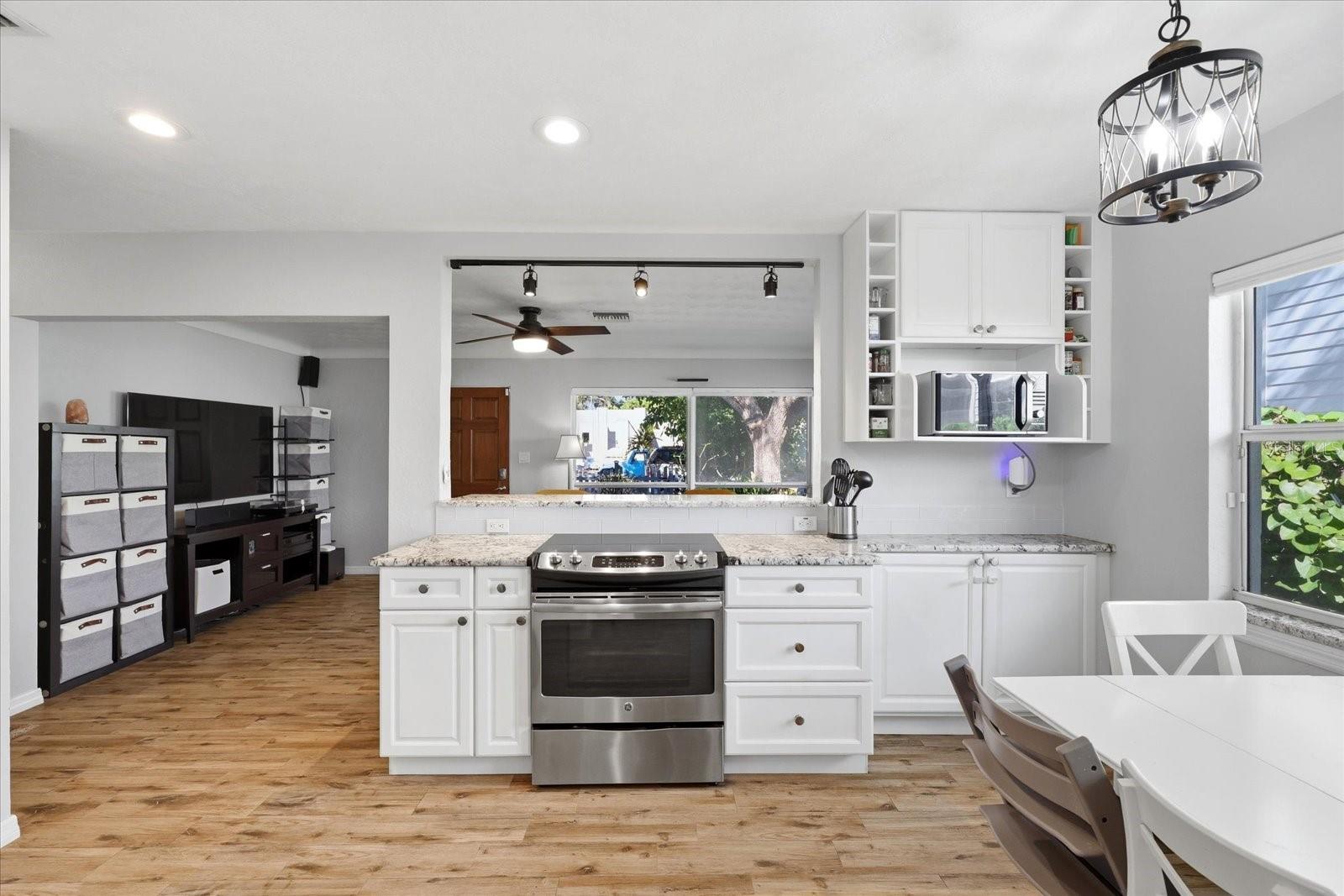Open kitchen with dining area and abundant natural light