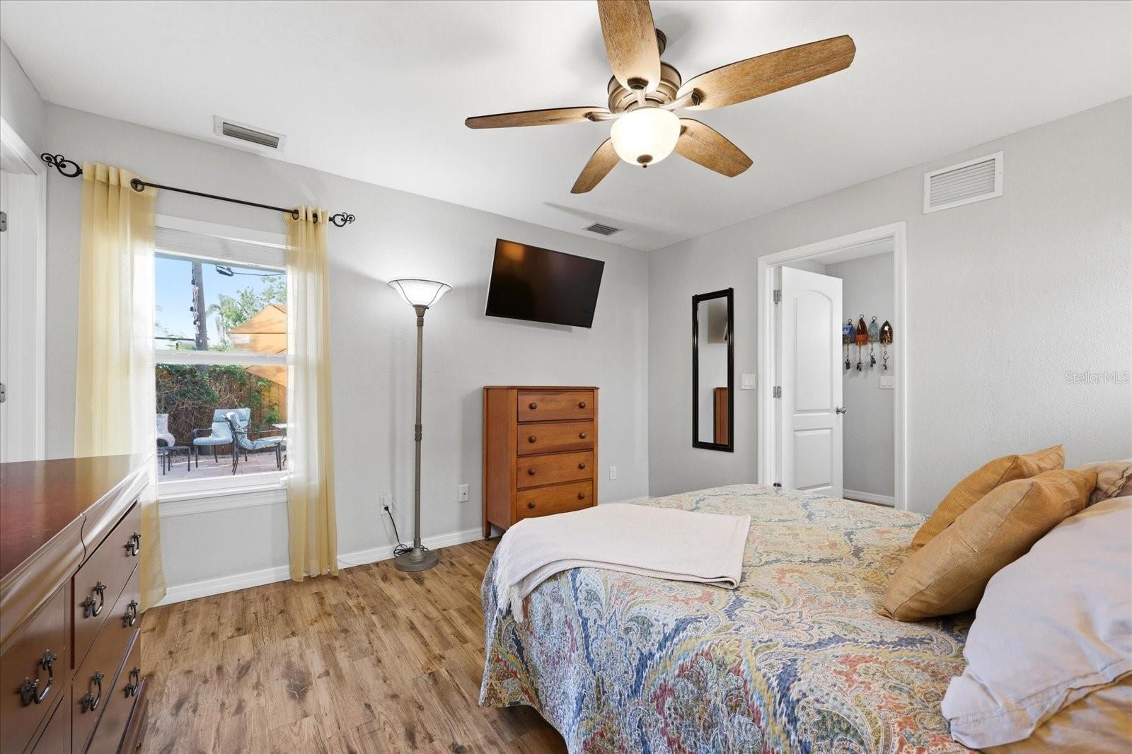 Primary bedroom with natural light and view of outdoor patio