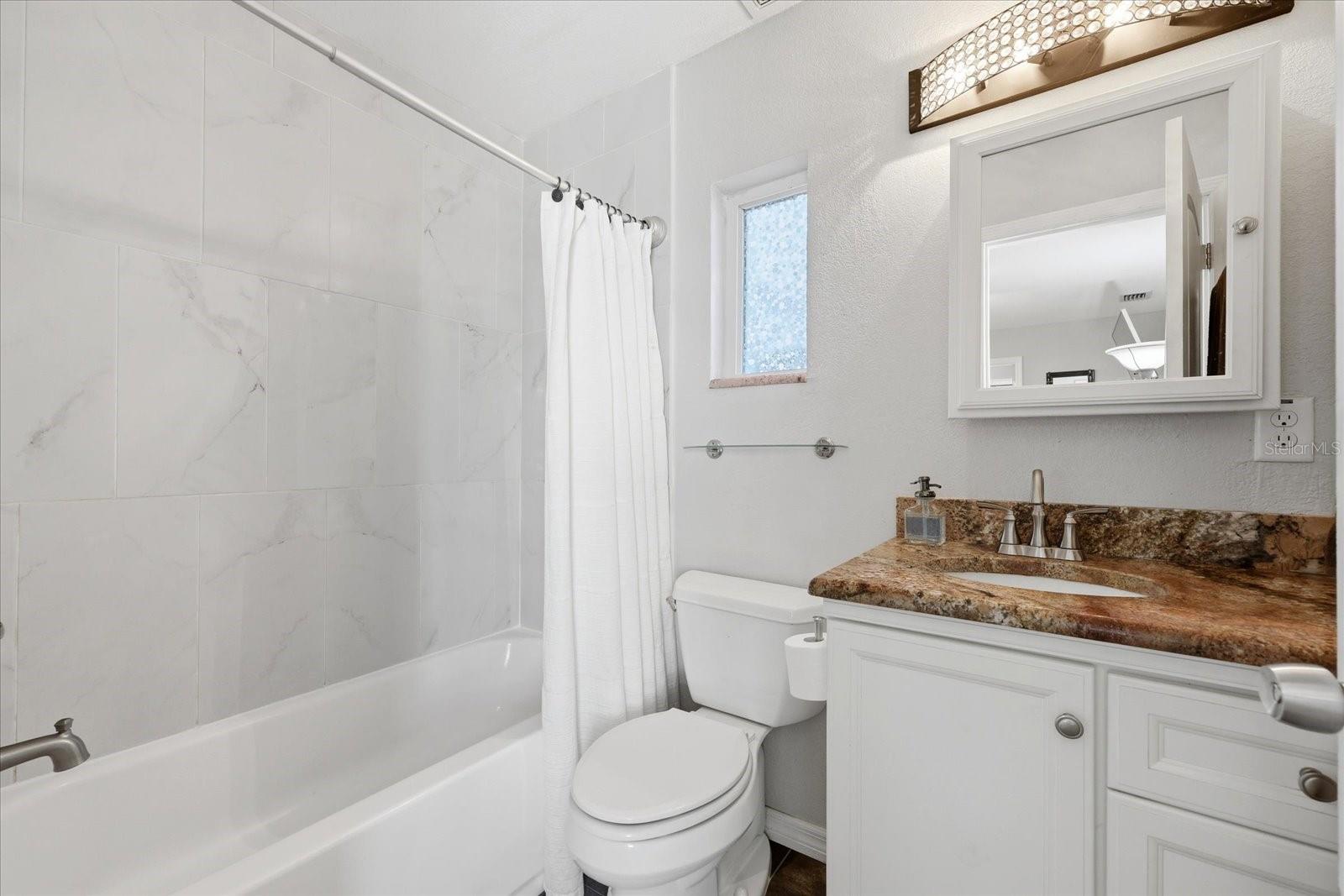 Updated bathroom with tiled shower and modern finishes