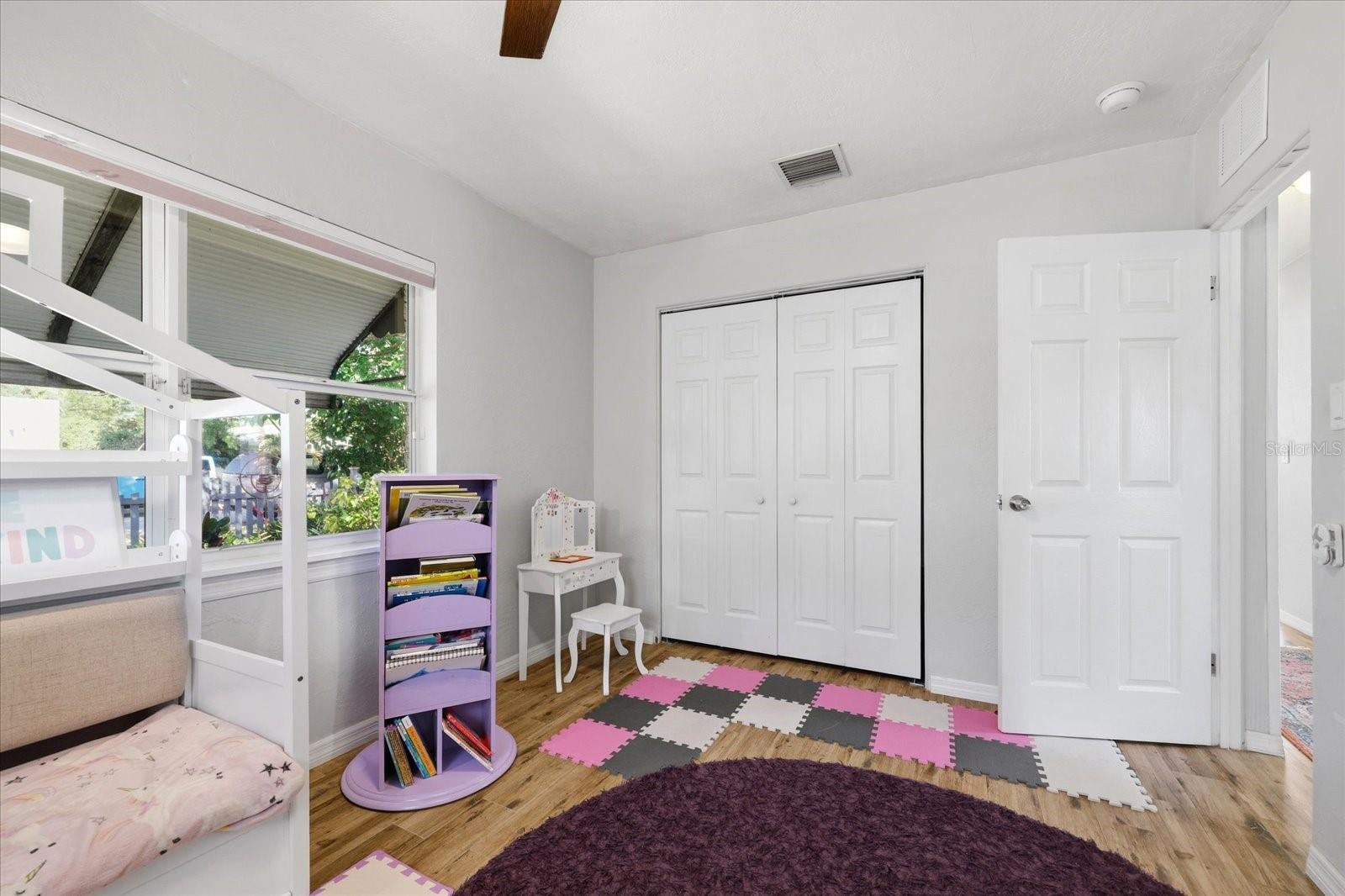 Alternate bedroom view highlighting layout and storage