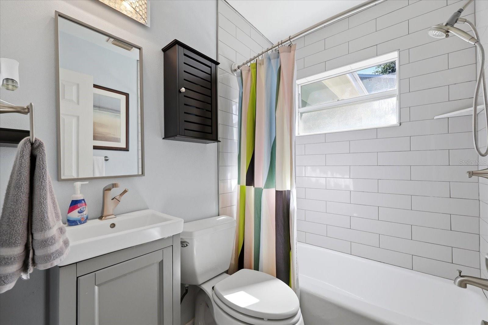 Updated bathroom with modern tile and natural light