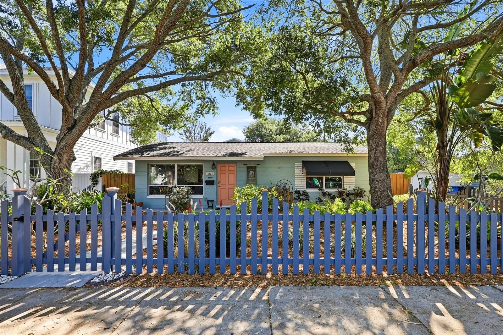 Spacious front yard with established greenery and shaded sitting areas