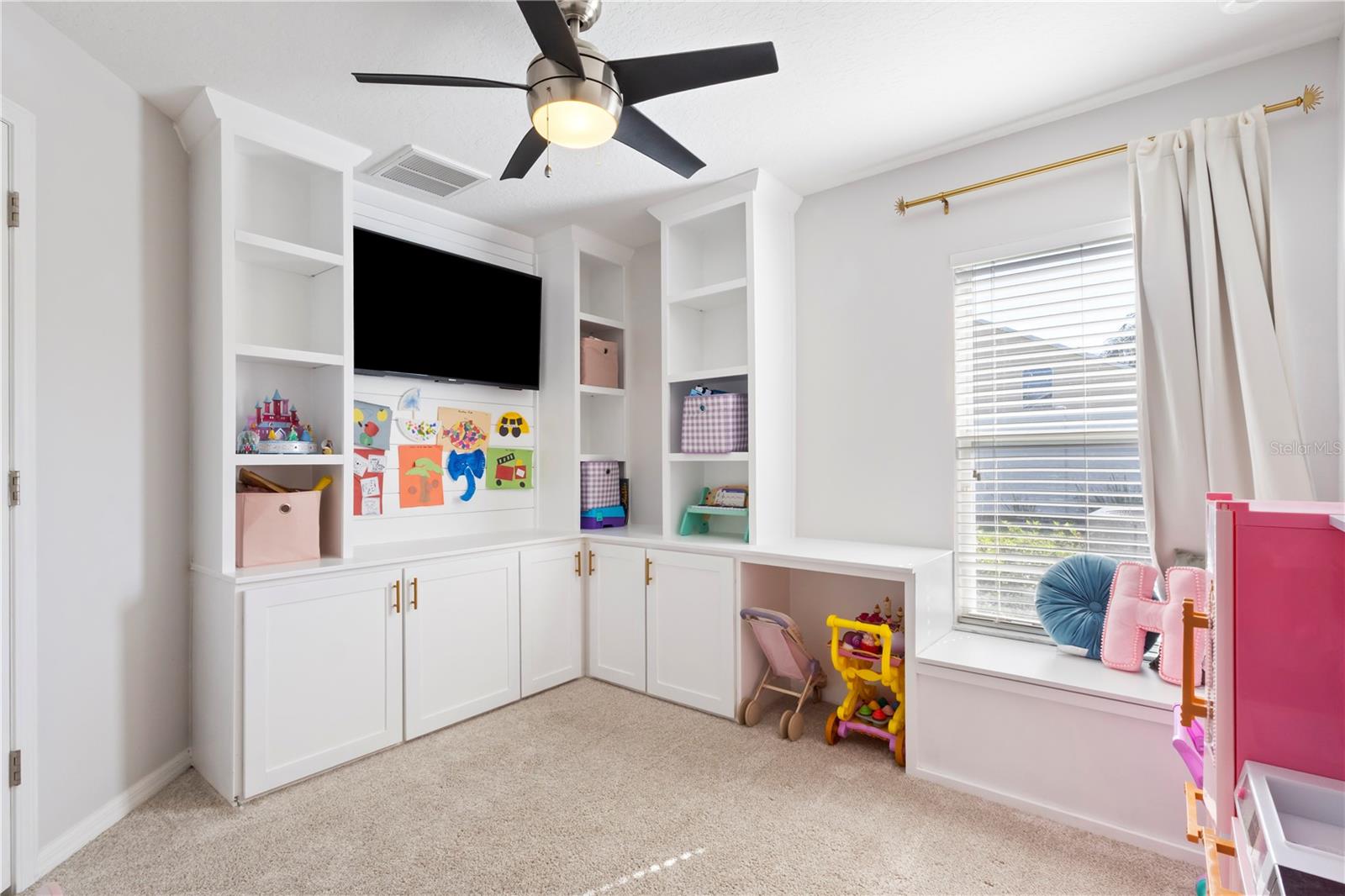 Turn this into a bedroom or office with the custom built-in shelving and storage.