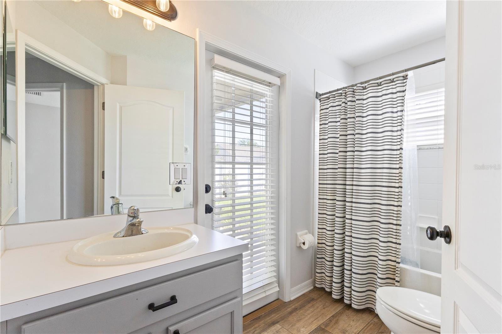 This could be a future pool bath, but for now, it leads to the private back yard!