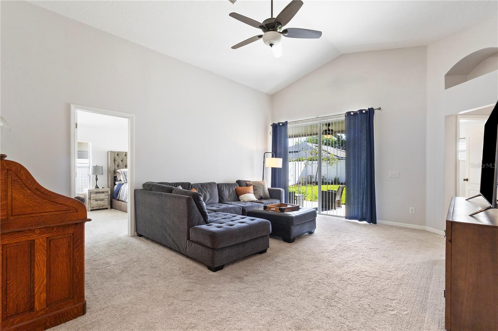 A spacious family room with vaulted ceiling and sliding glass doors leading to the beautiful back yard!