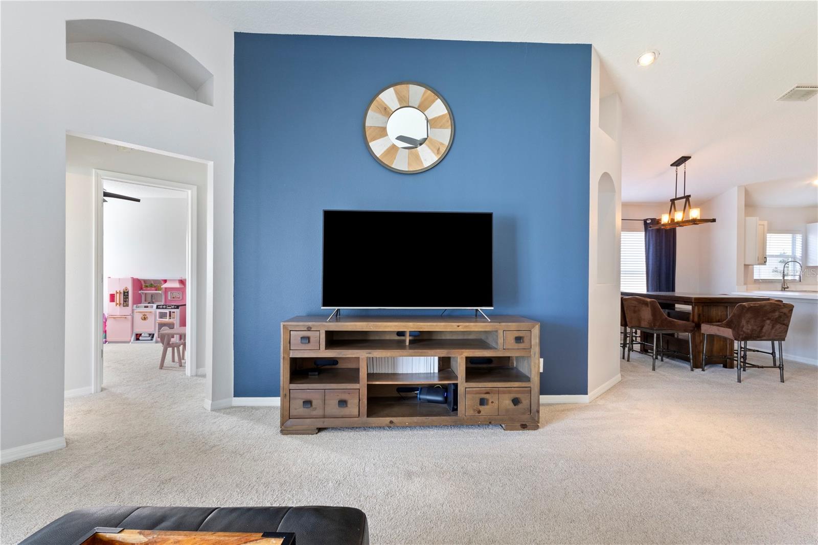 Wow! The architectural details in the walls highlight your family living space that opens to either the kitchen and dining gathering area, or the hallway to the 2 extra bedrooms!